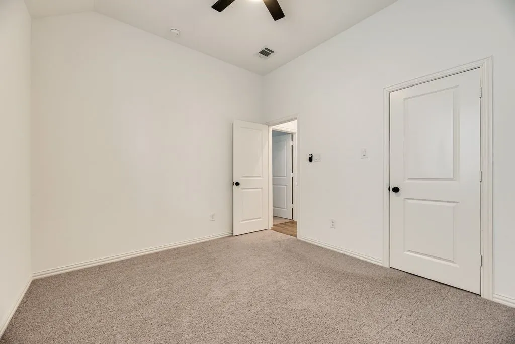 Vaulted ceiling, recessed lighting, ceiling fan, neutral carpet flooring, and white paneled doors