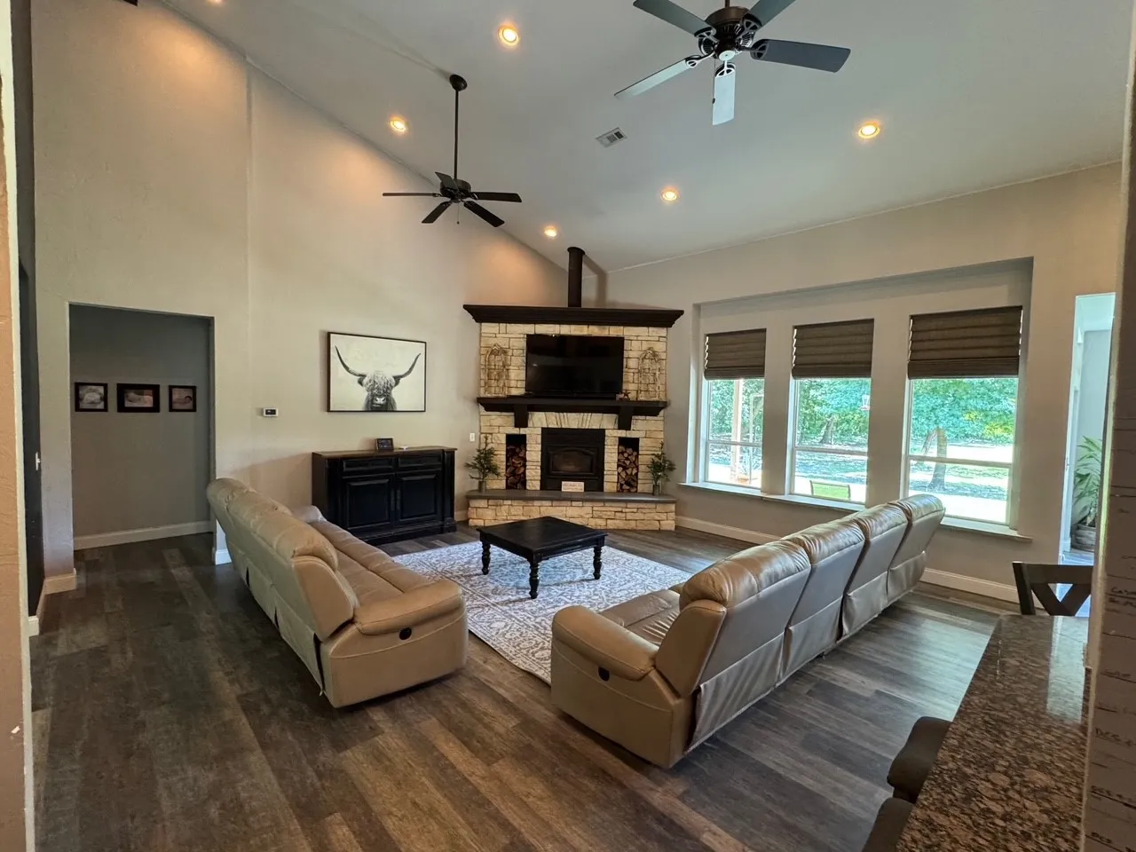 Vaulted ceiling with recessed lighting and ceiling fans