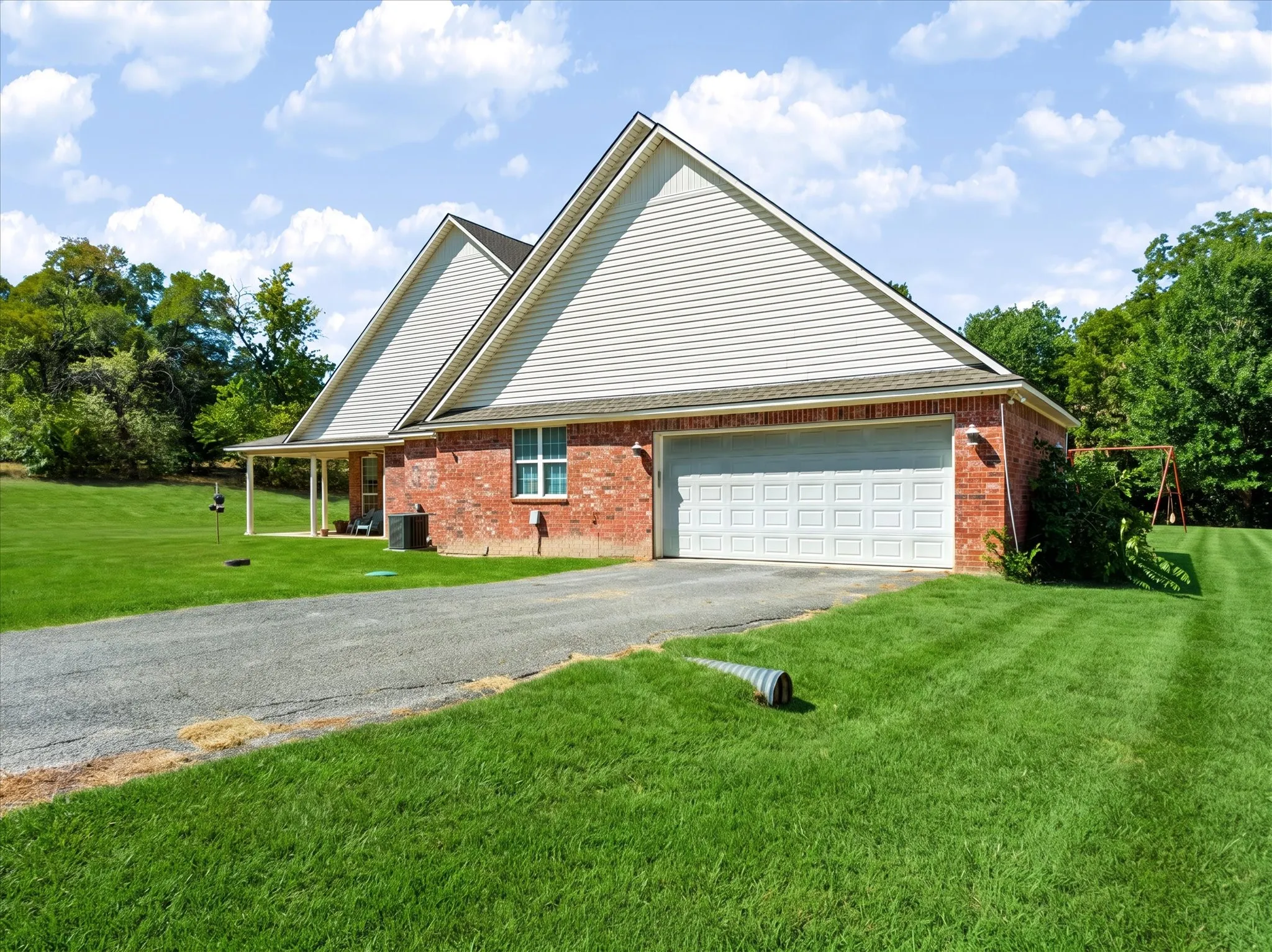 Brick exterior with white siding accents and an attached garage