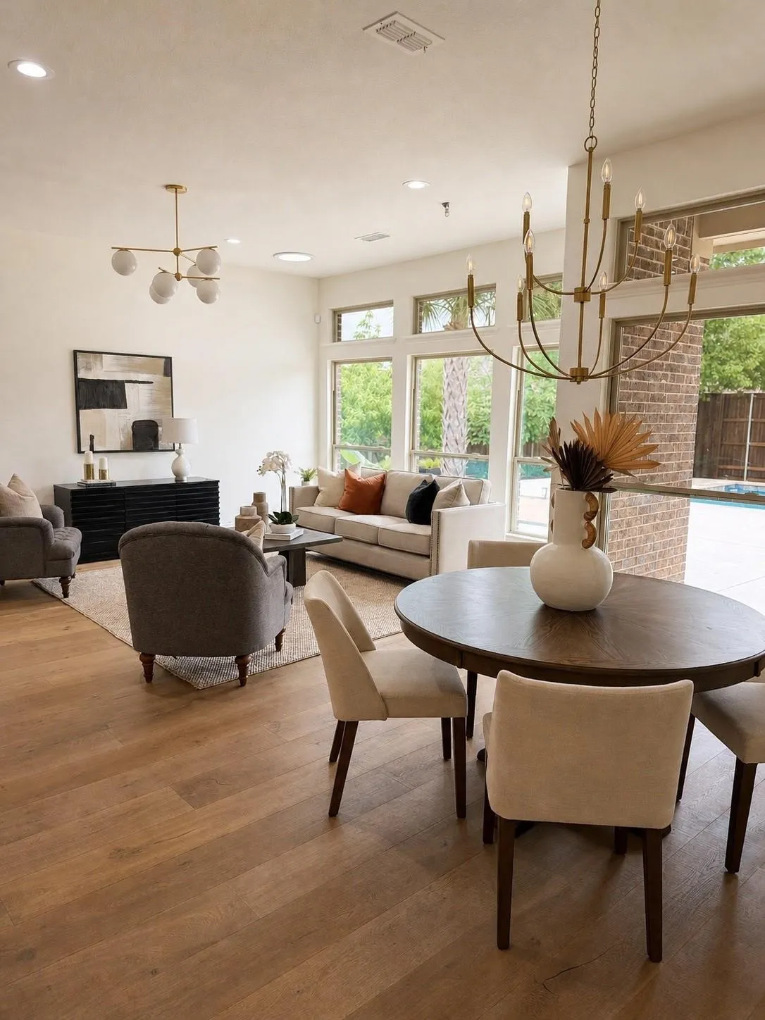Expansive interior featuring wood-finish flooring, recessed lighting, and a multi-pane window wall