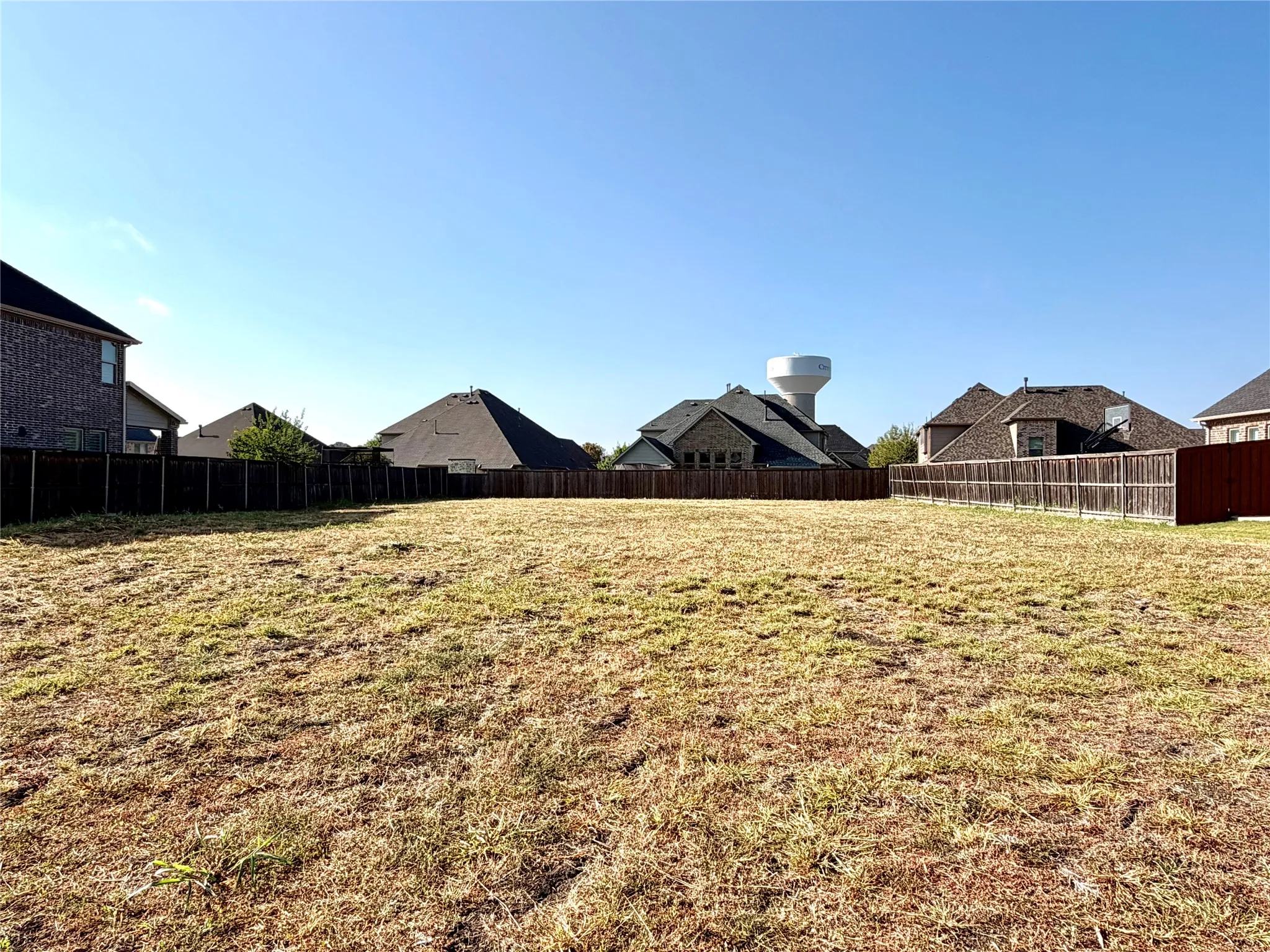 Expansive lot featuring perimeter fencing