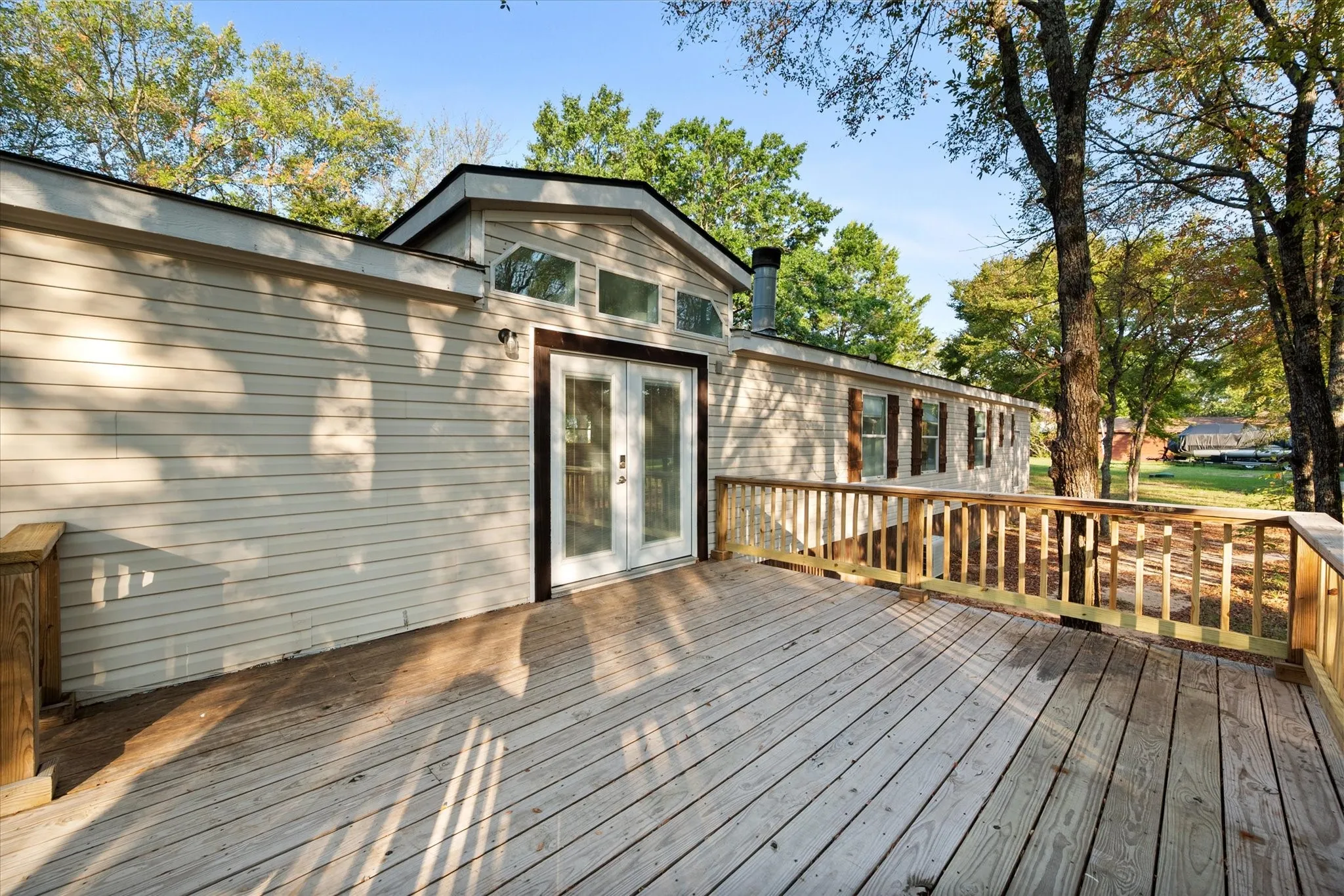 Expansive wood deck with a natural finish, featuring wood railings