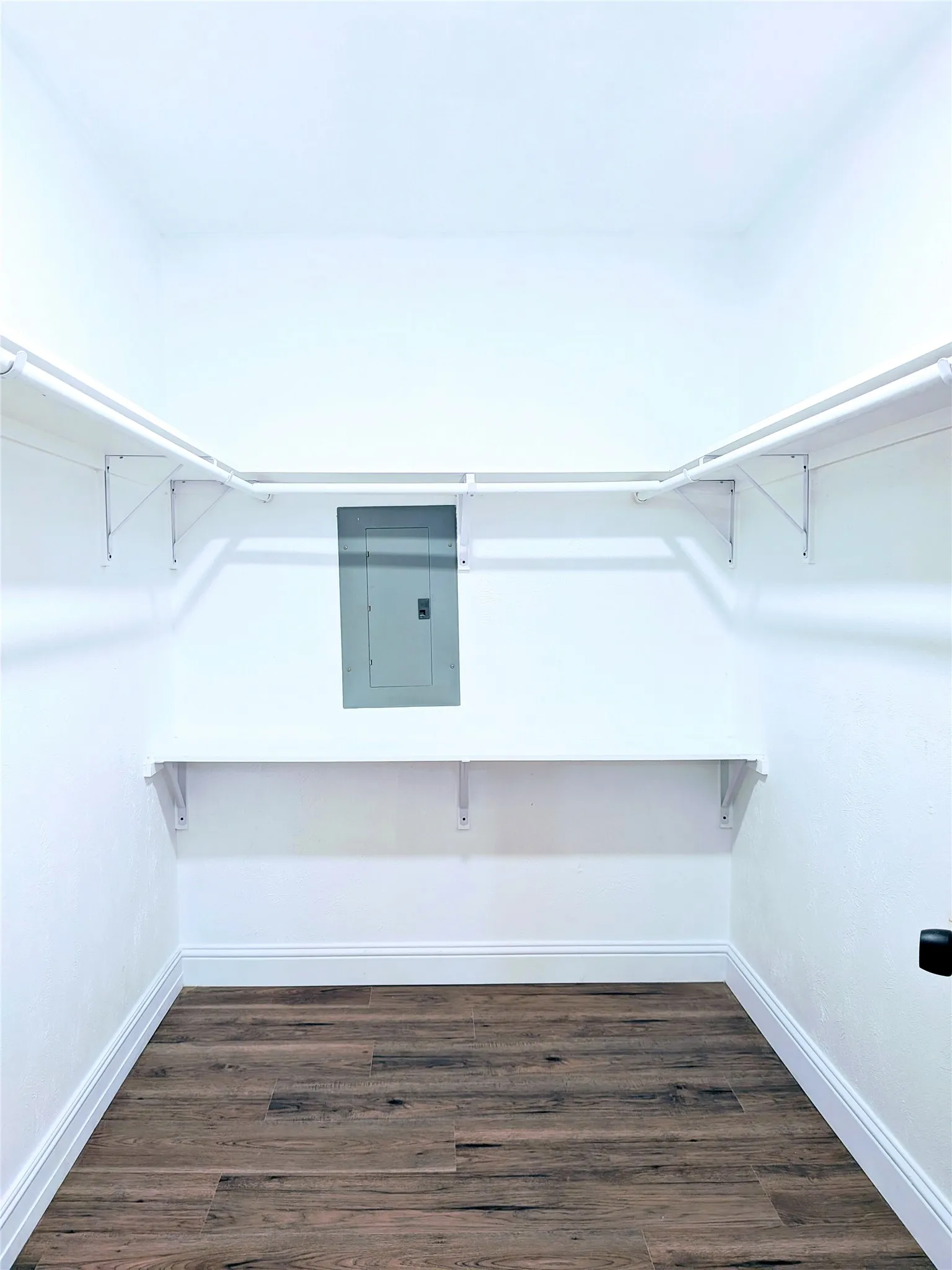 Wood-finish flooring with white walls and trim