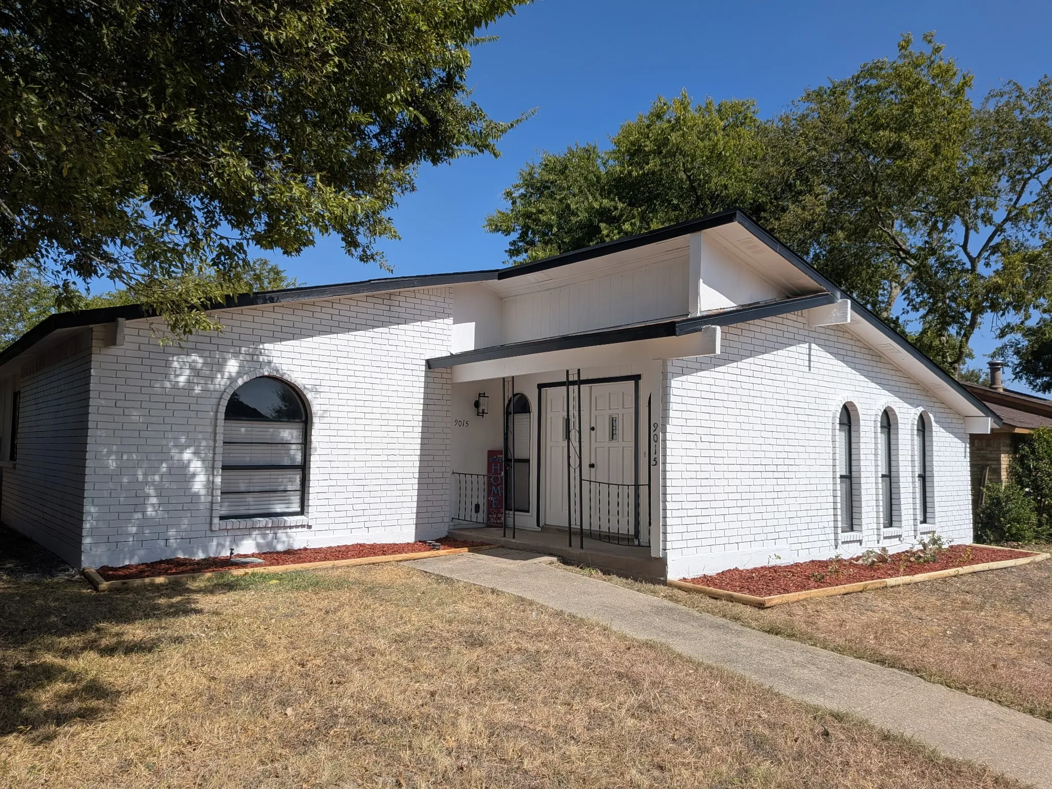 White brick exterior with black trim detailing