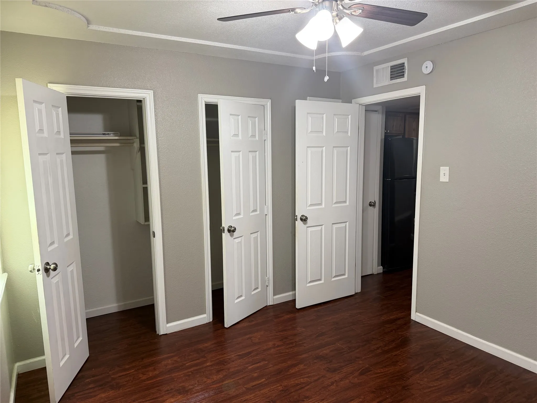 Wood-finish flooring with neutral wall tones and white trim