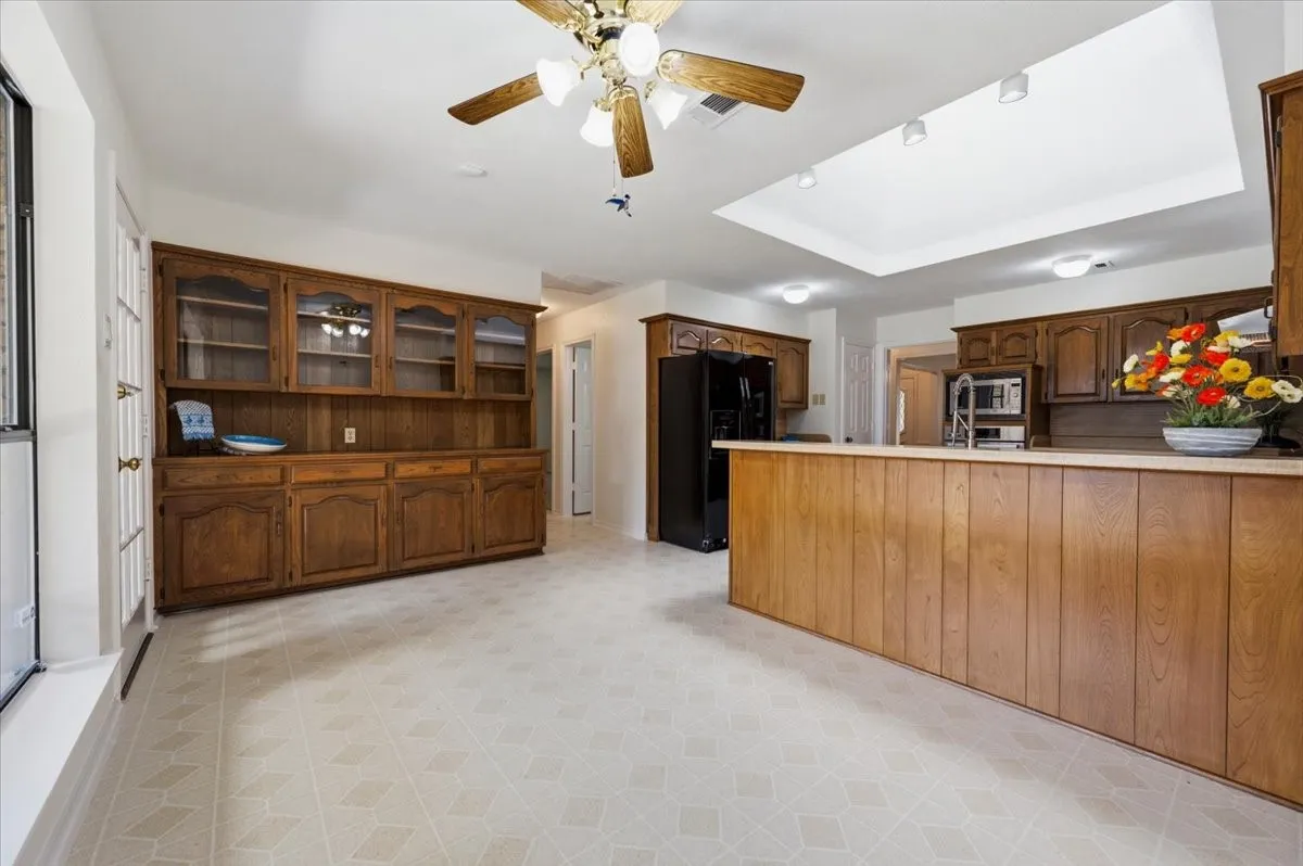 Lovely hutch with lots of storage, glass doors to display special items - ceiling fan in the breakfast area plus a view to the large covered patio