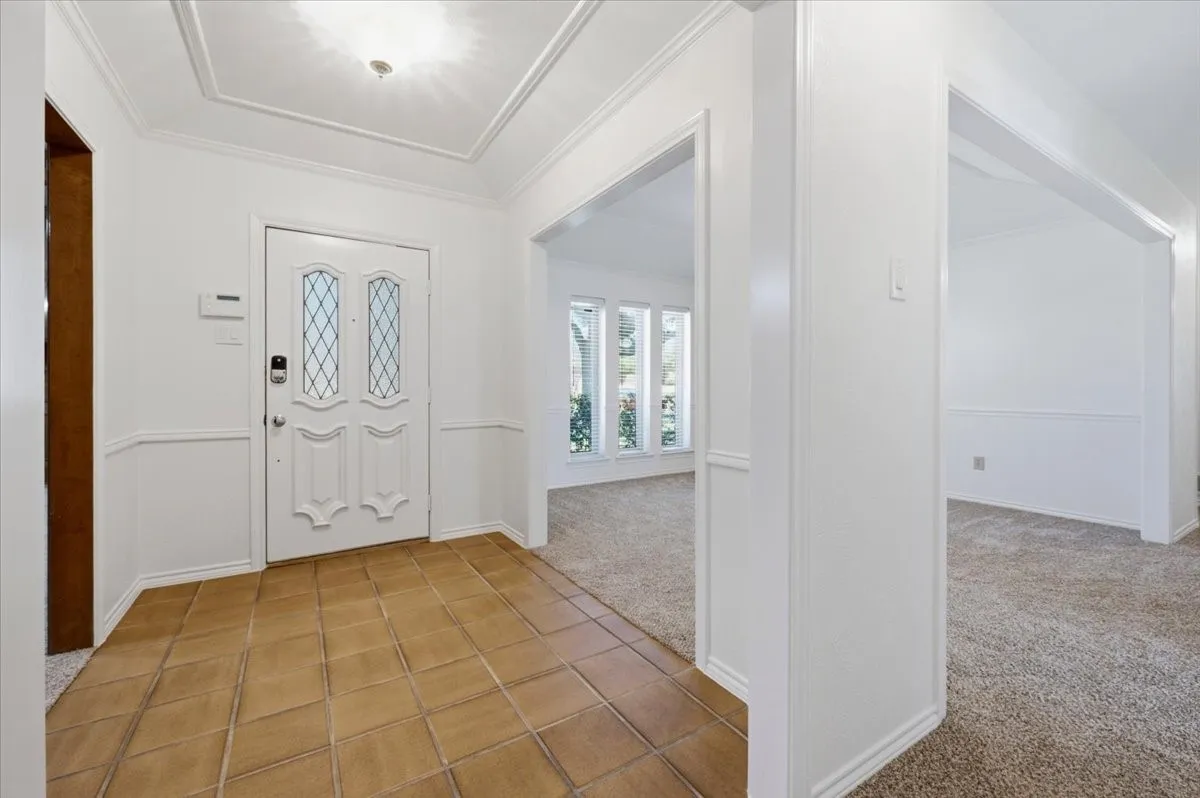 Large walk-in entry area with view and opening to formal dining - total home was painted, walls, ceilings, trim, moldings and new carpeting after painting