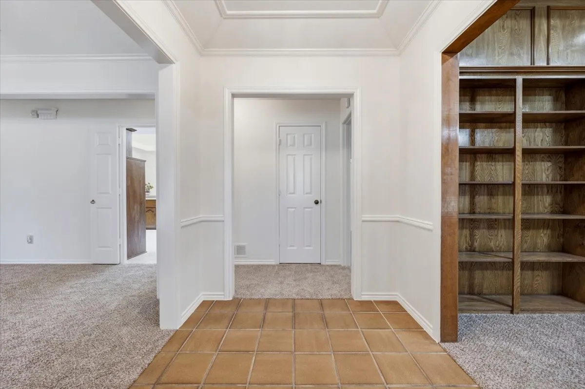 To the right  is the living room that features a full wall of bookshelves