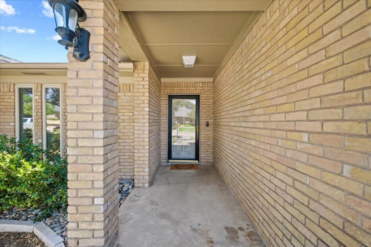 Close up view of front door with covered area