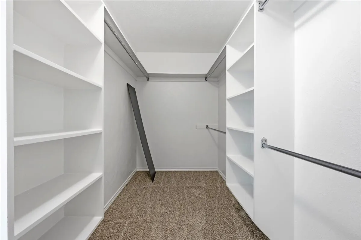Primary bedroom closet
with shelves and rods