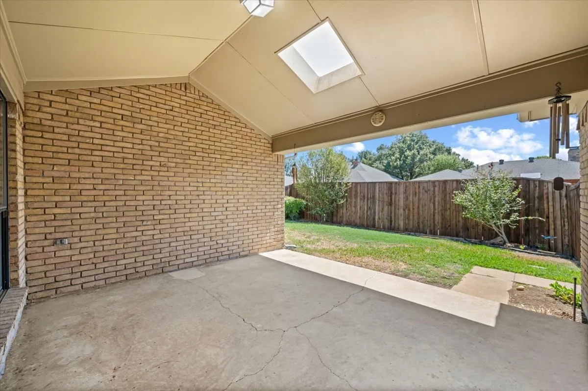 Back covered patio area with skylight
with skylight - large fenced yard on alley with 6ft wood fence