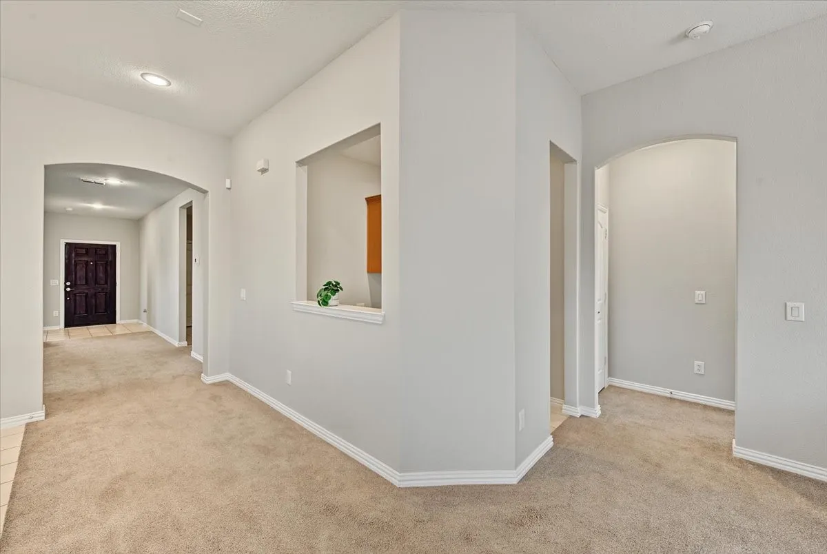 Arched doorways, recessed lighting, and an interior wall niche