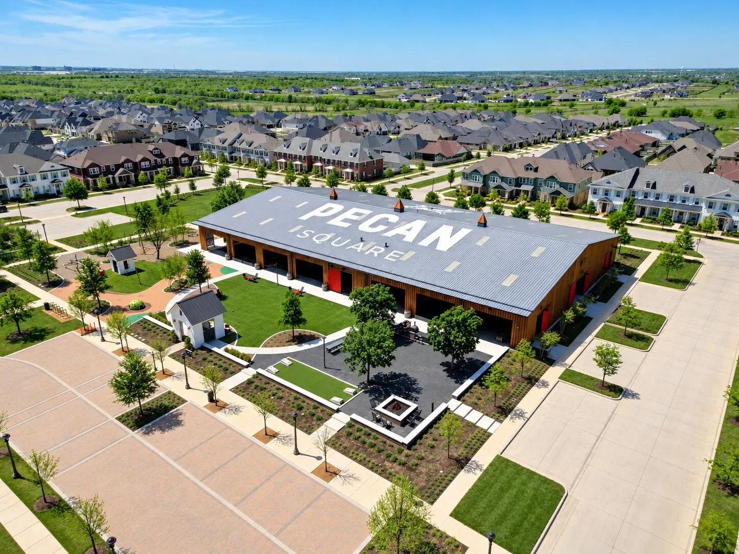 The Arena at Pecan Square offers indoor sports courts and versatile gathering space, complemented by nearby playgrounds, game areas, fire pits, and inviting outdoor spaces.