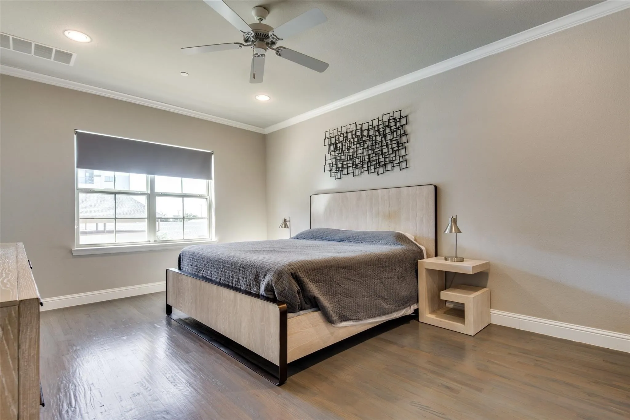 Wood-finish flooring with crown molding and recessed lighting