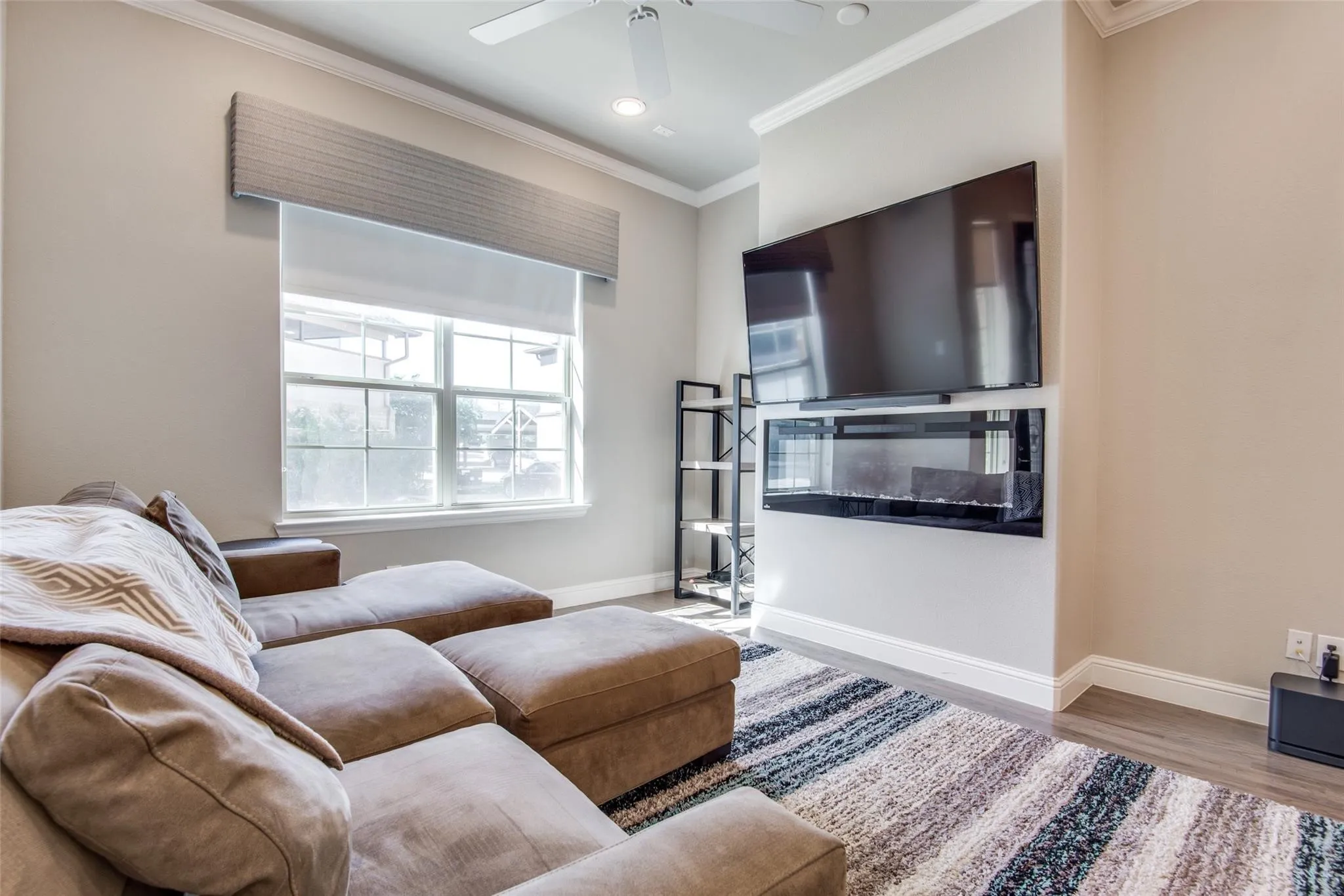Installed linear electric fireplace with integrated media display