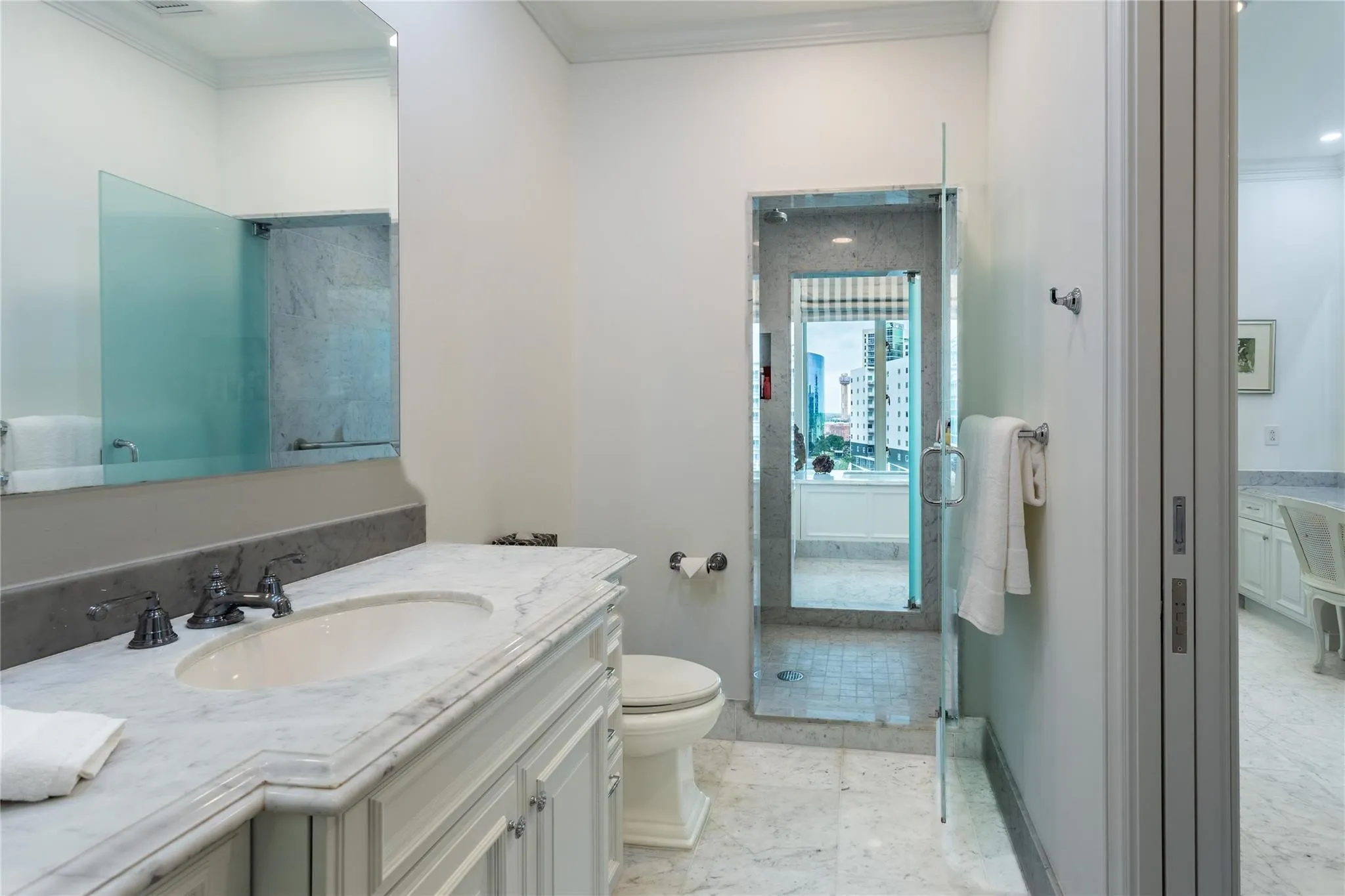 Second Primary Bath has large vanity, water closet & shared double shower.