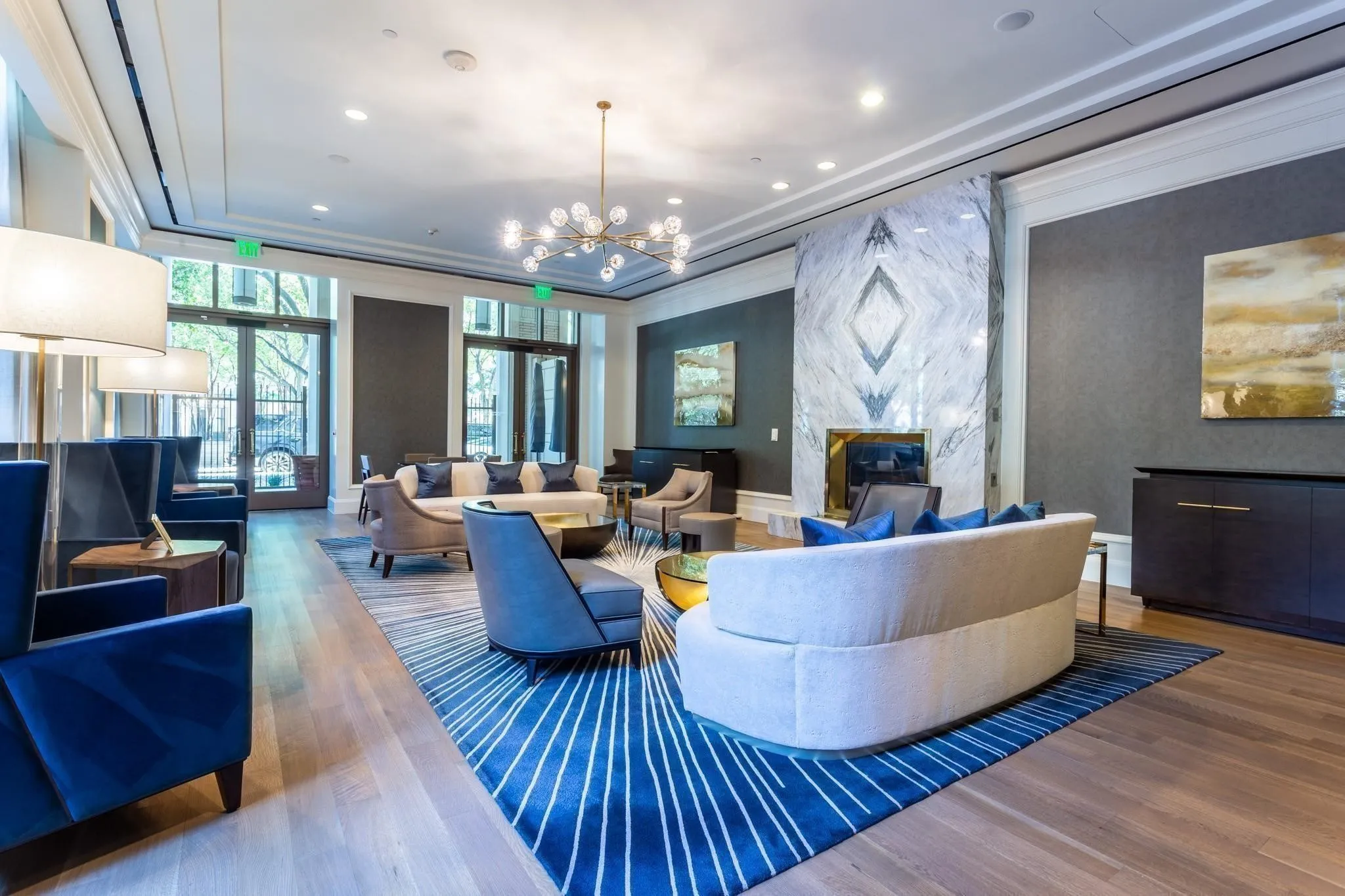 Owners' Lounge with book-matched marble fireplace & two credenzas with pop-up TVs
