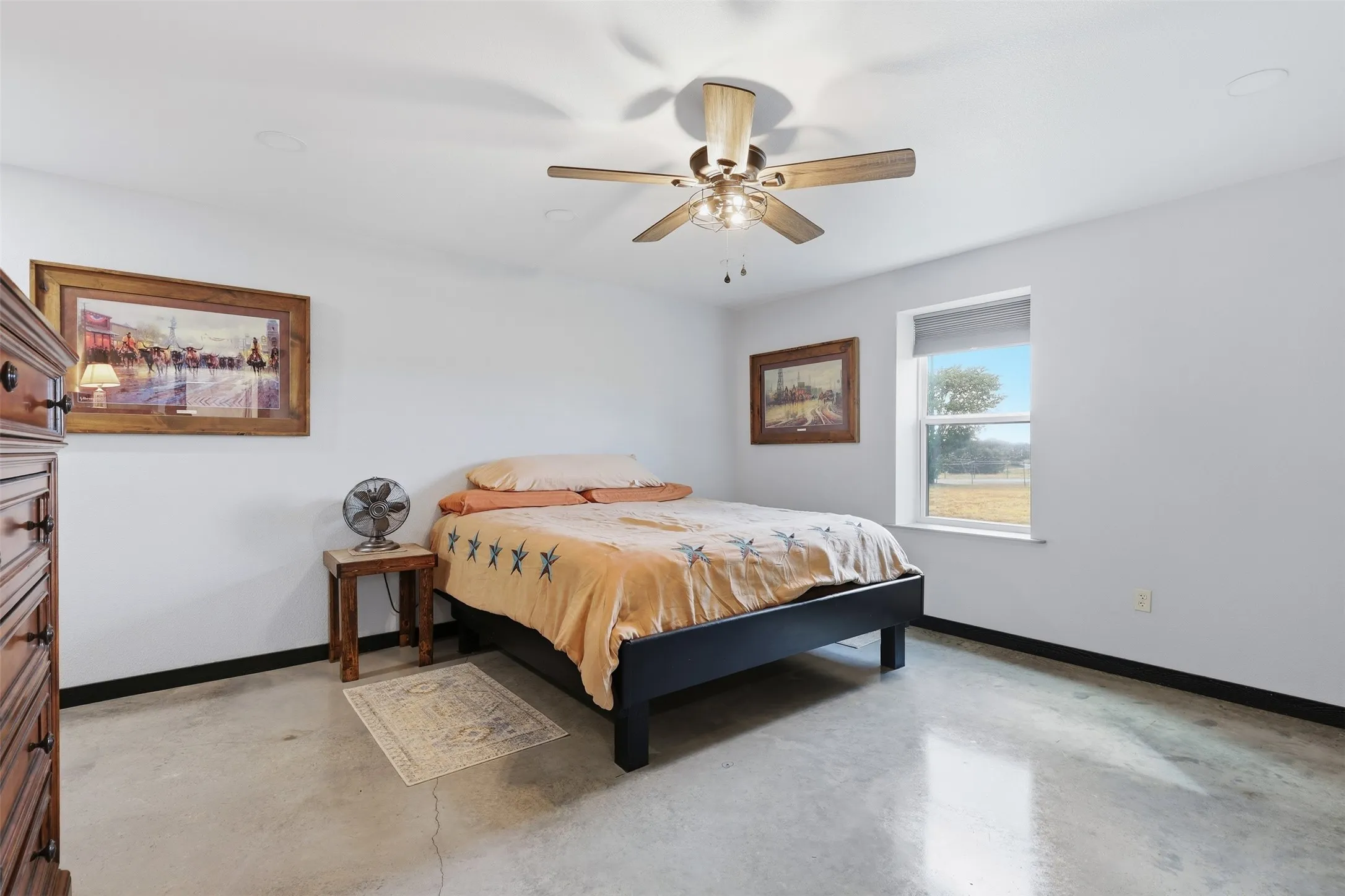 Polished concrete flooring, recessed lighting, and a ceiling fan with integrated lighting