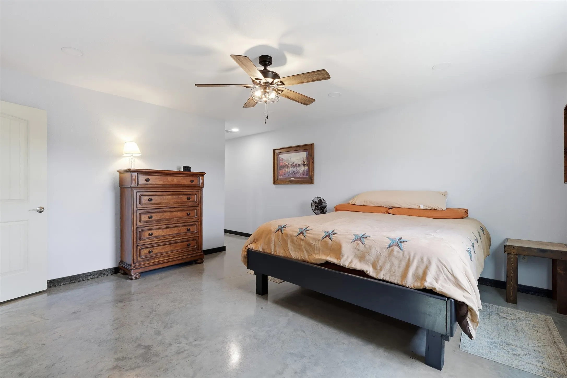 Polished concrete flooring, recessed lighting, and a ceiling fan with light fixture