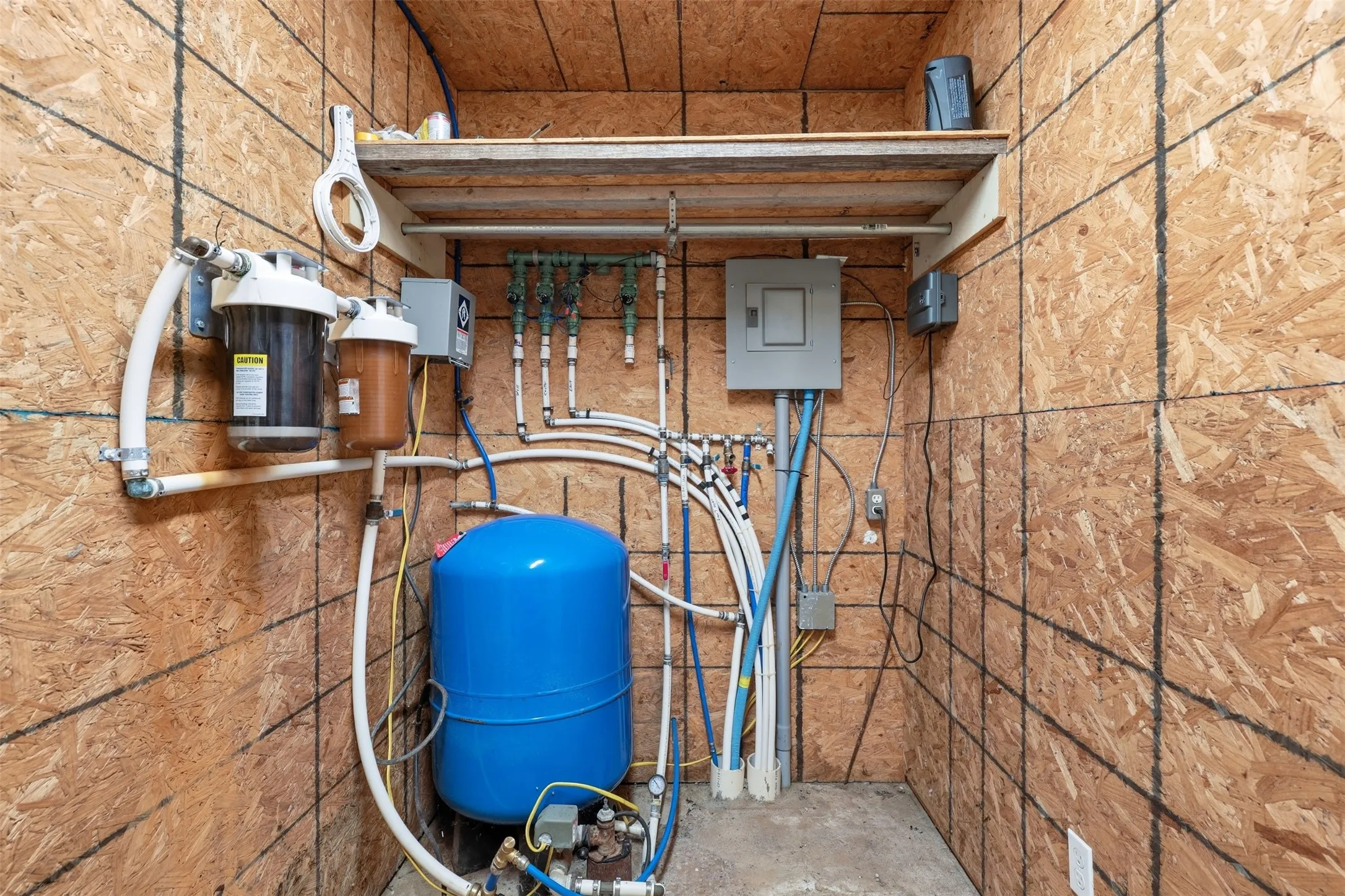 Water filtration system, pressure tank, electrical panel, and PEX plumbing