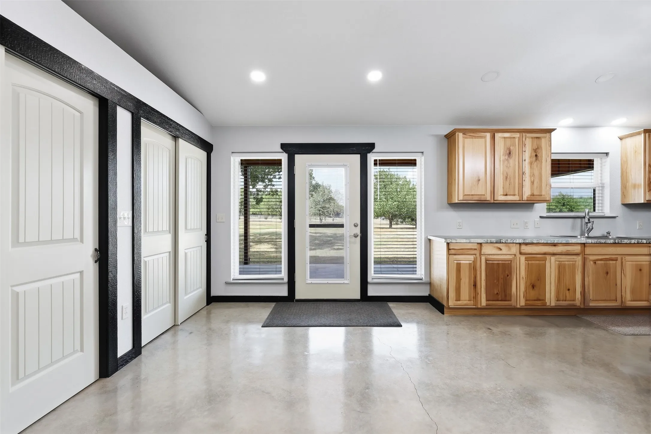 Open-concept living space with polished concrete flooring