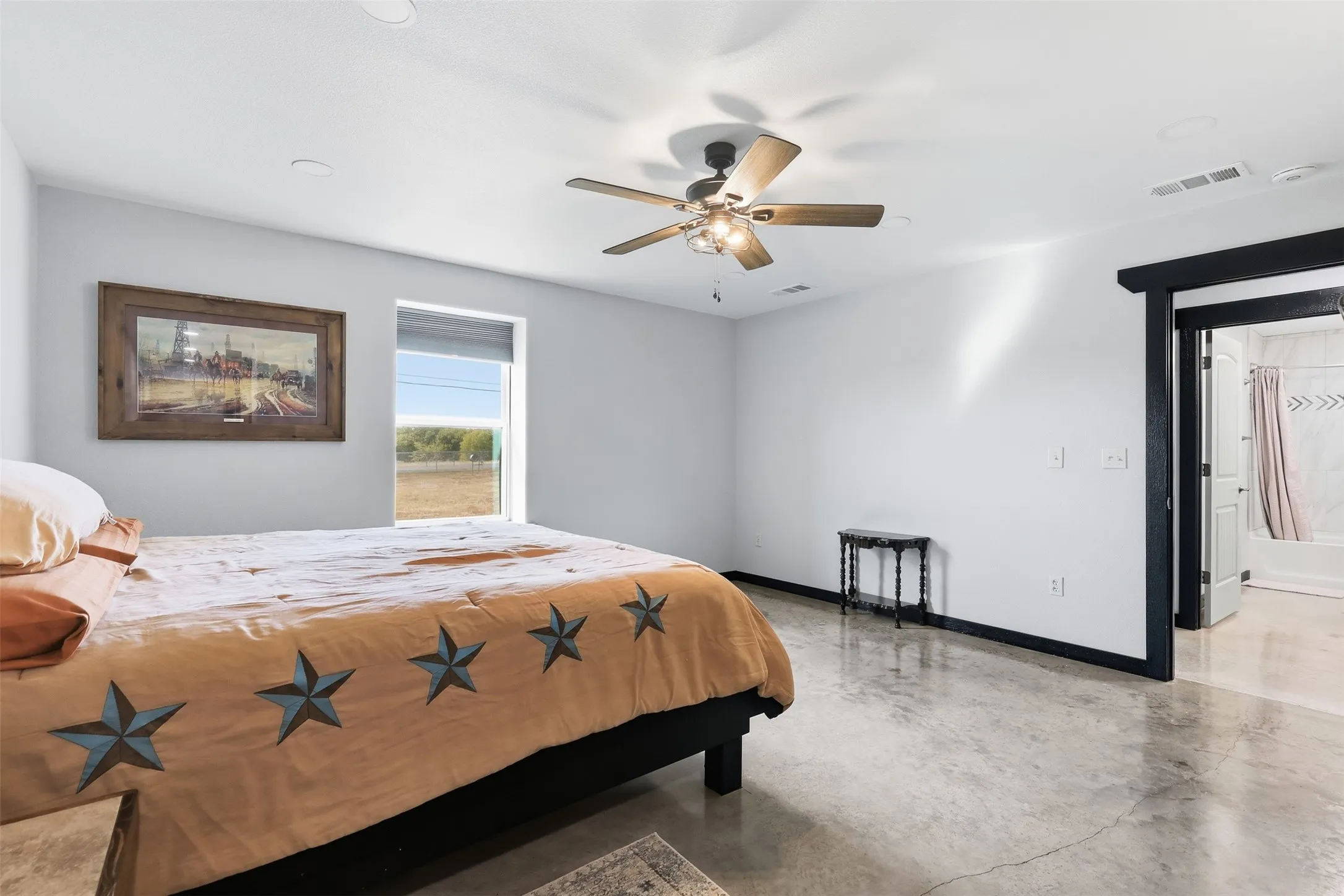 Polished concrete flooring, recessed lighting, ceiling fan, and a window with outdoor scenery