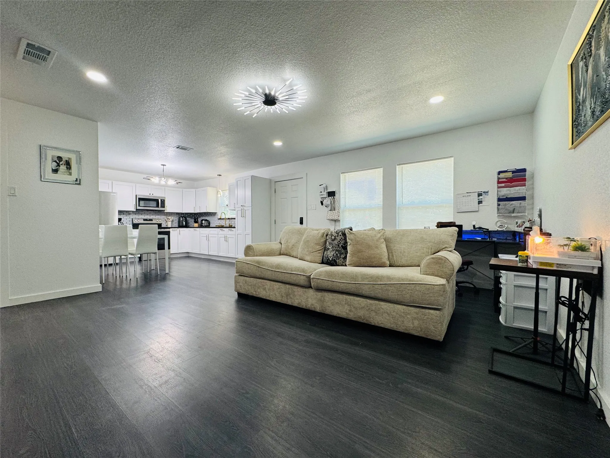 Open-concept living area with dark wood-finish flooring