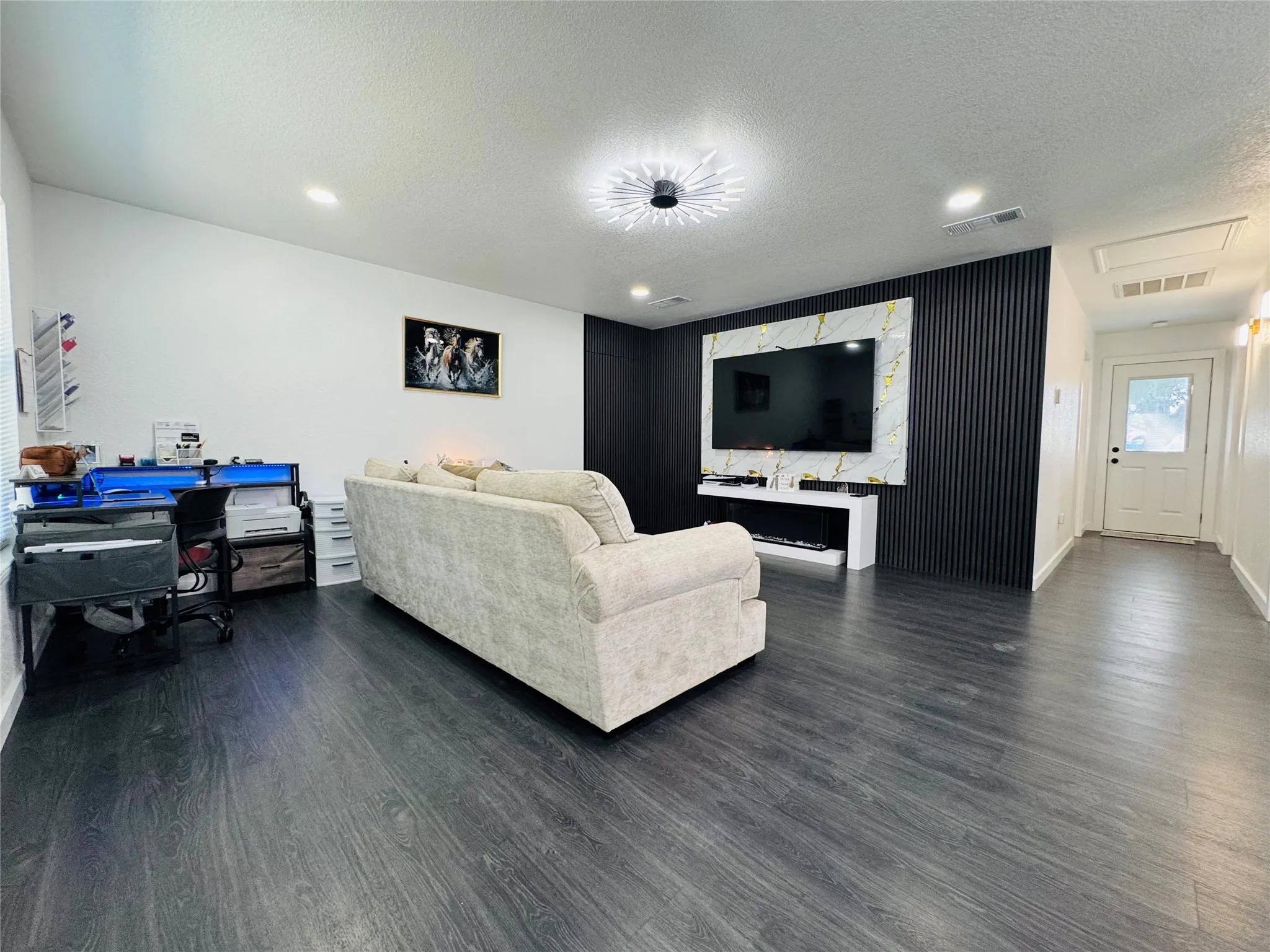 Wood-finish flooring, recessed lighting, and a modern ceiling fixture