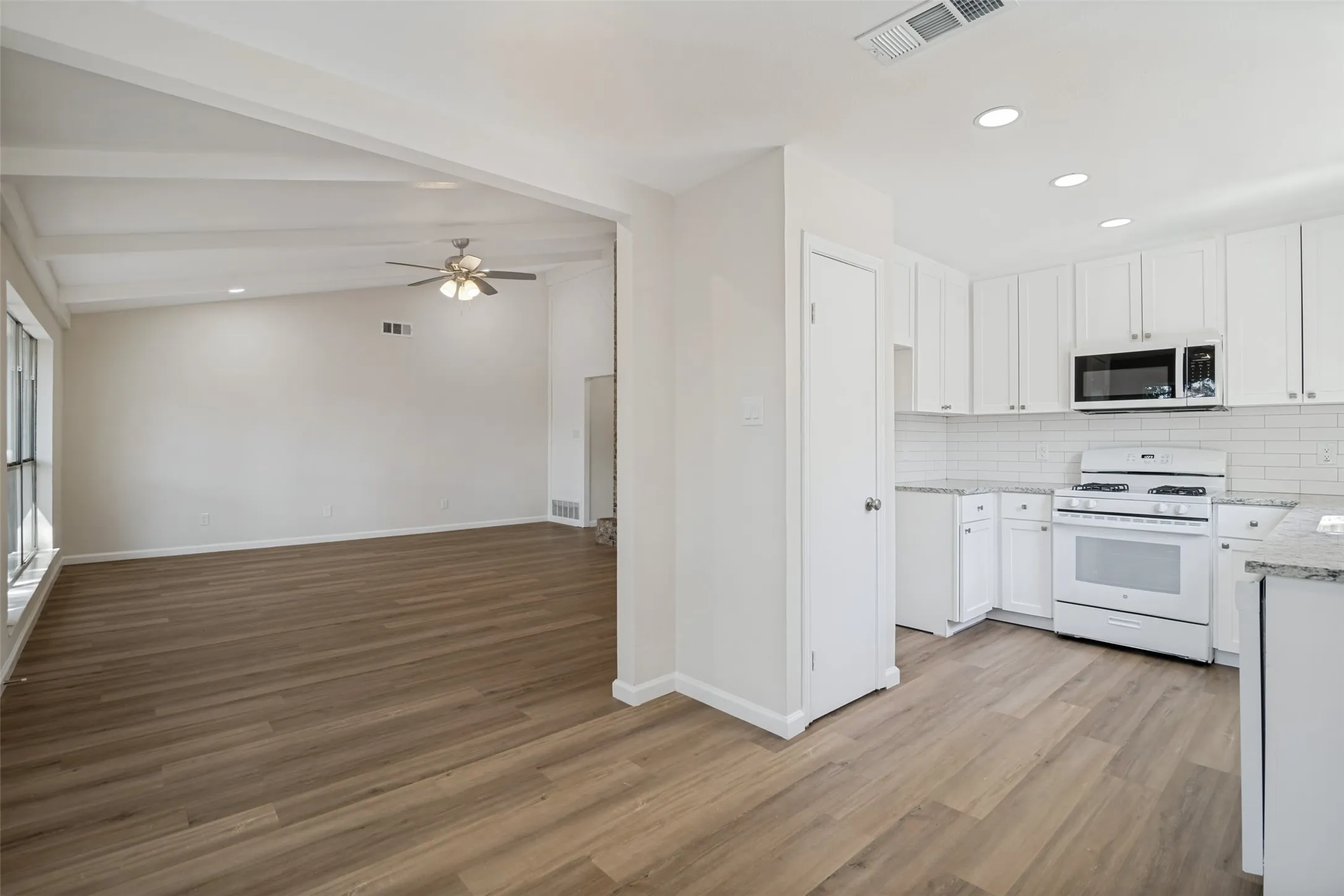 Kitchen is located off the large living room