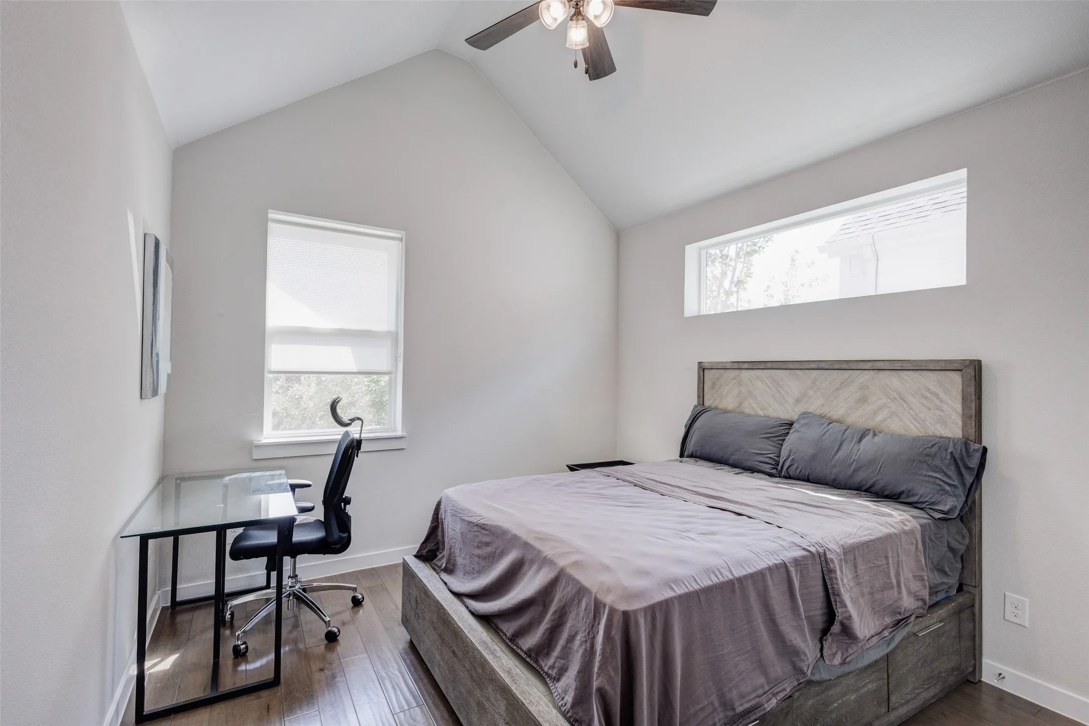3rd bedroom with ceiling fan and vaulted ceiling