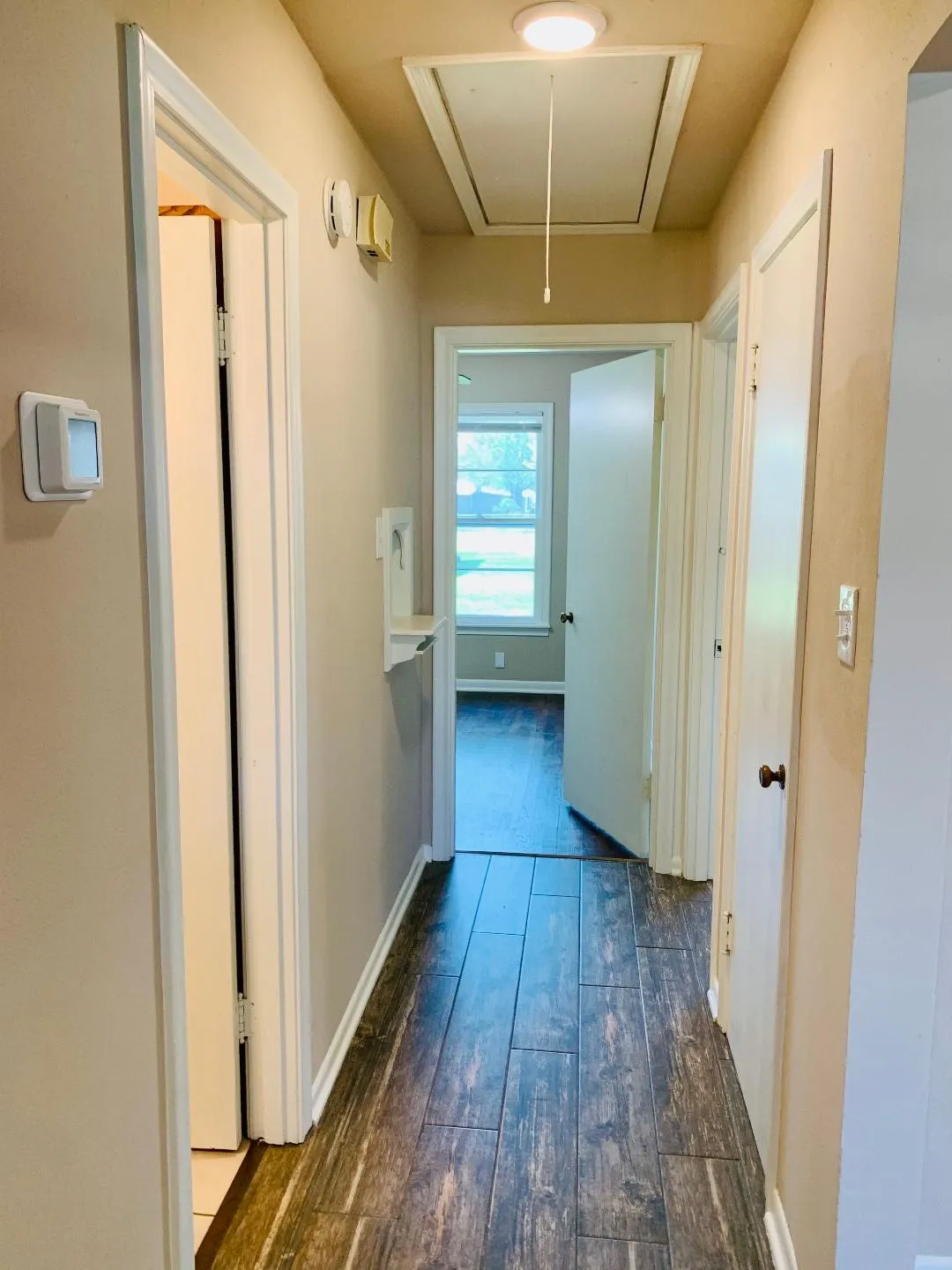 Wood-finish flooring throughout the hallway