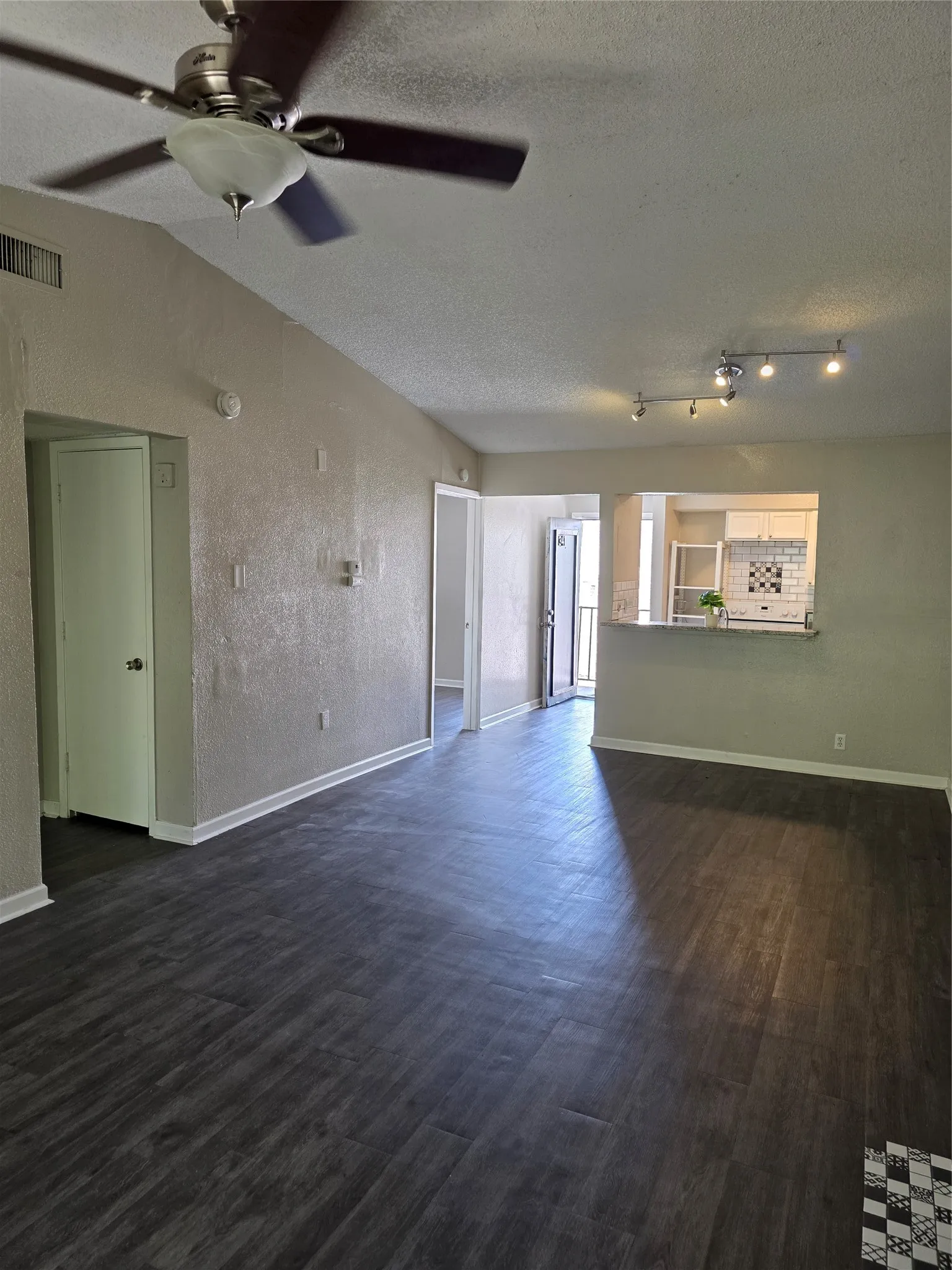 Vaulted ceiling featuring a ceiling fan with integrated lighting
