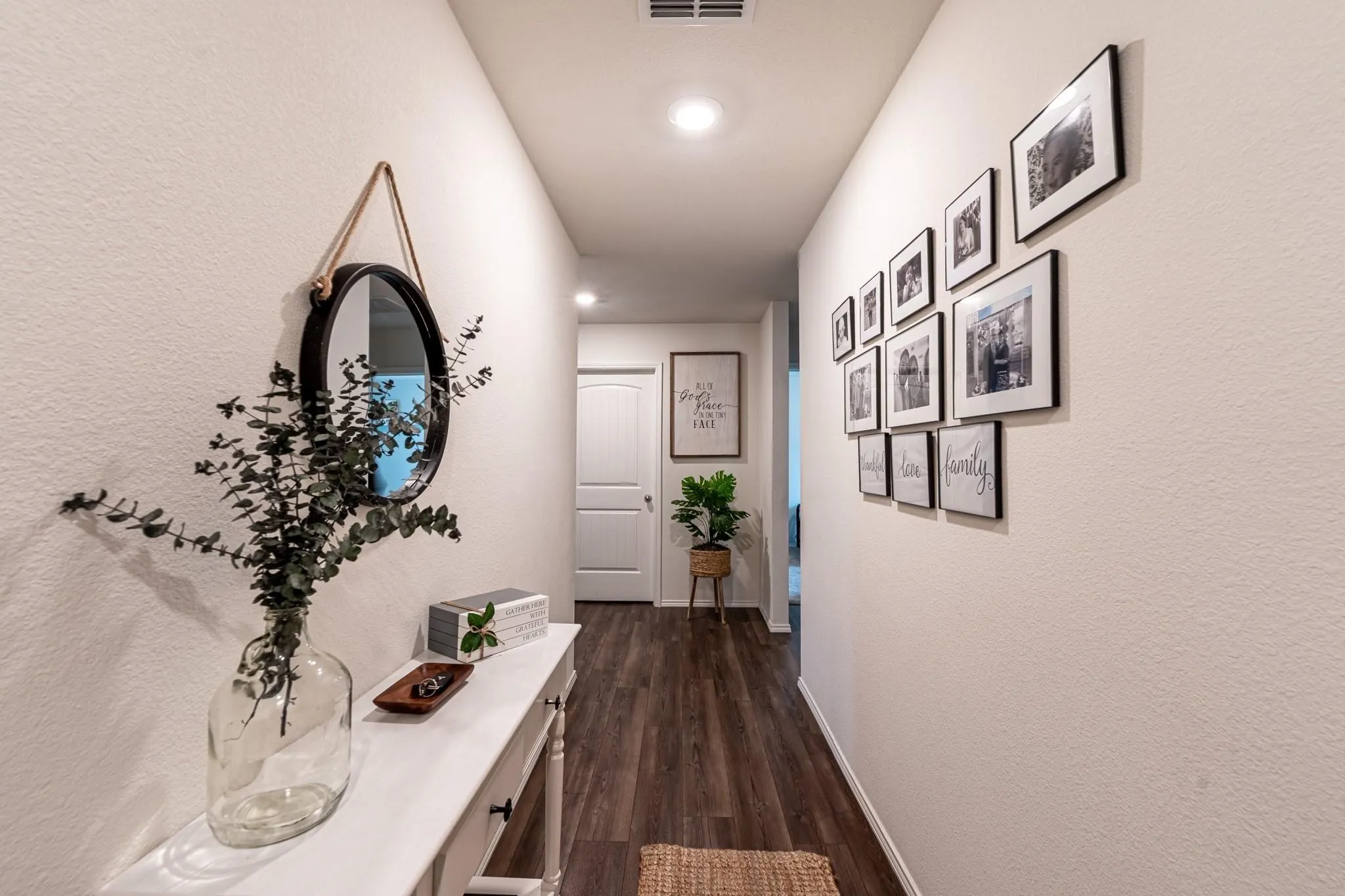 Hall with dark hardwood / wood-style floors