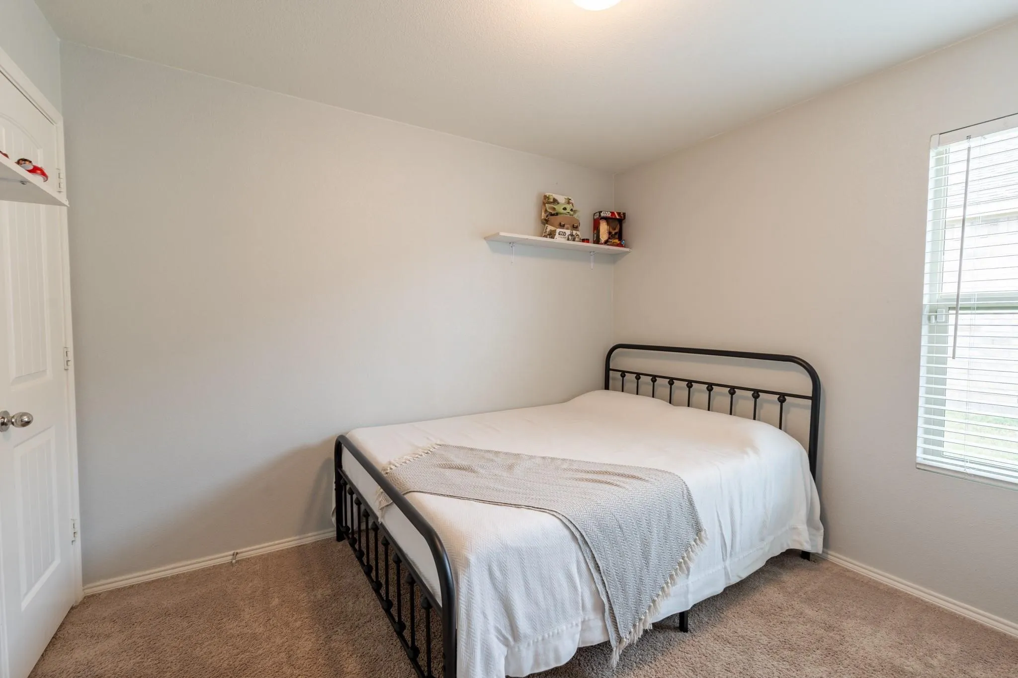 Bedroom with carpet flooring and multiple windows