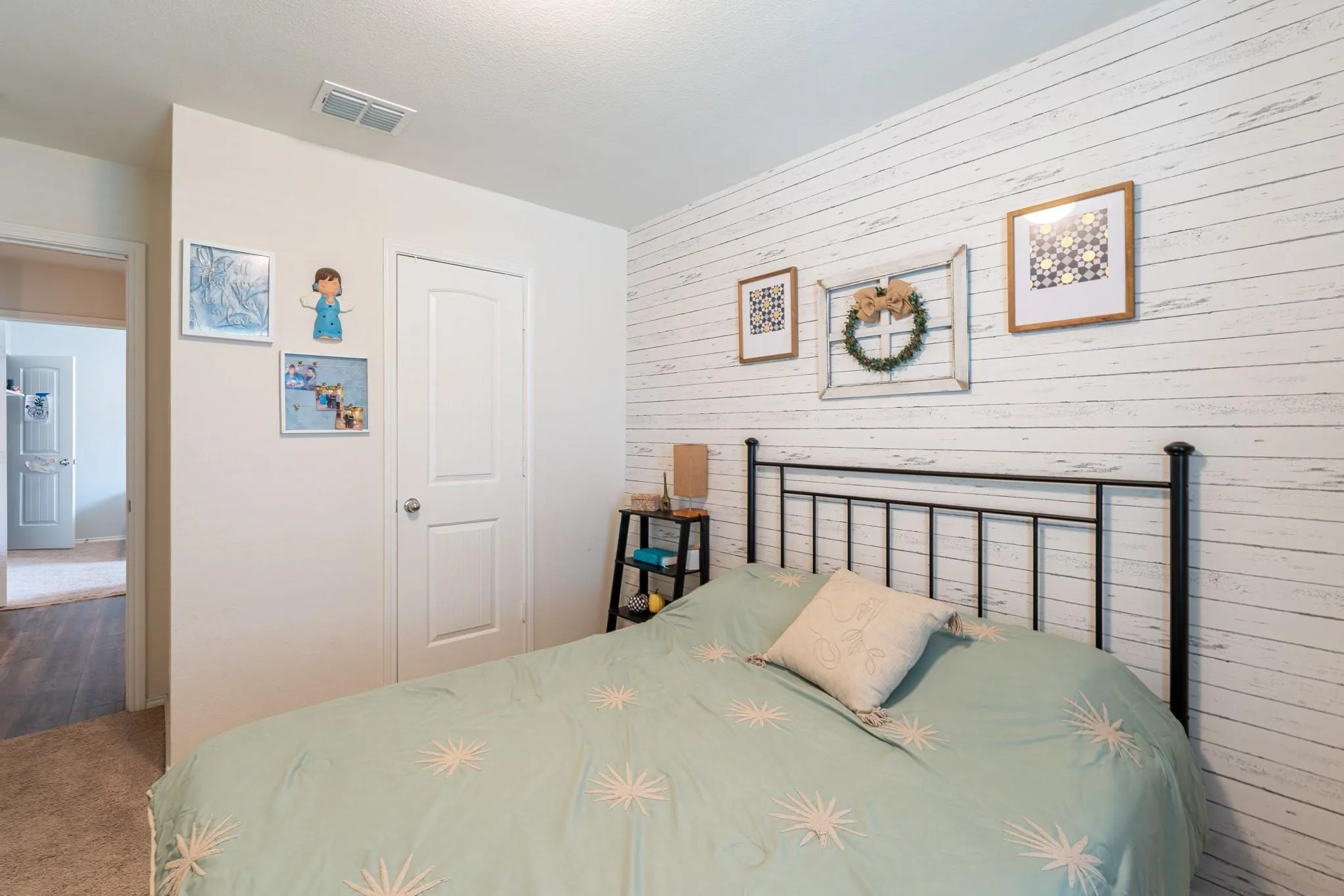 Bedroom featuring wooden walls and dark carpet