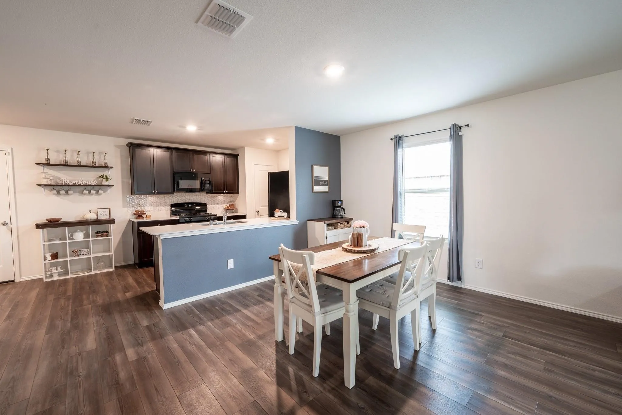 Dining area featuring sink and dark hardwood / wood-style flooring