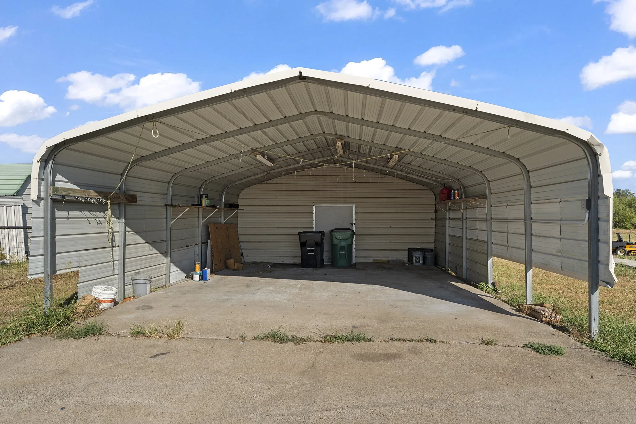 Two car carport with a mechanic shop in the back