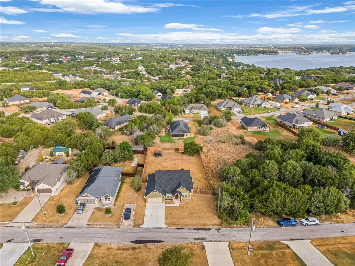 Residential neighborhood with mature trees and a distant body of water