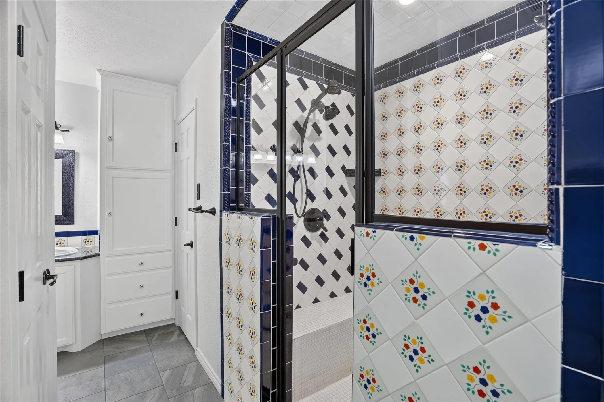 The primary bath has separate sinks/vanities, a huge shower with dual shower heads, and walk in closets.