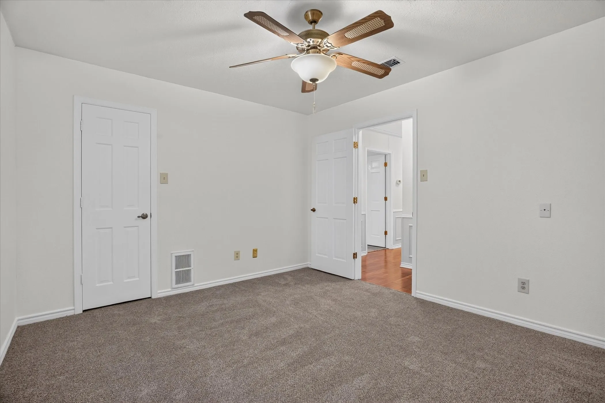 Downstairs bedroom 2  with new carpet and a walk in closet