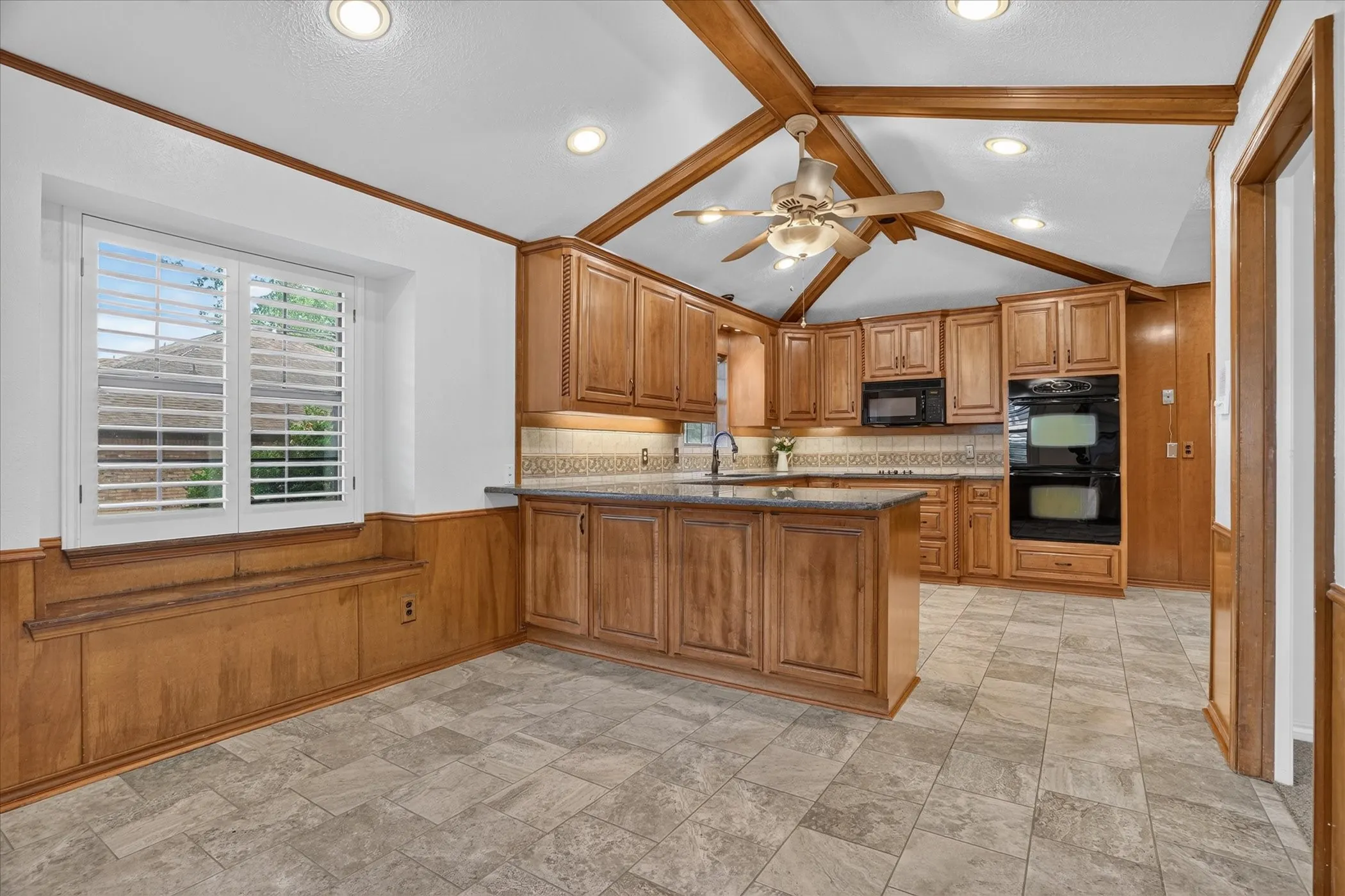 Kitchen featuring granite countertops, double oven, and plenty of space
