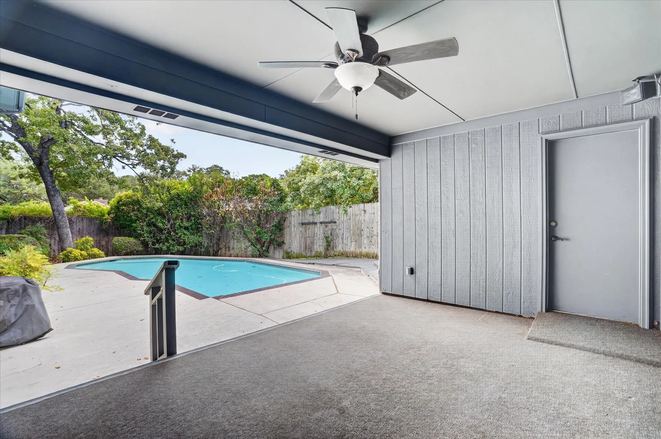 Covered patio with a pool view