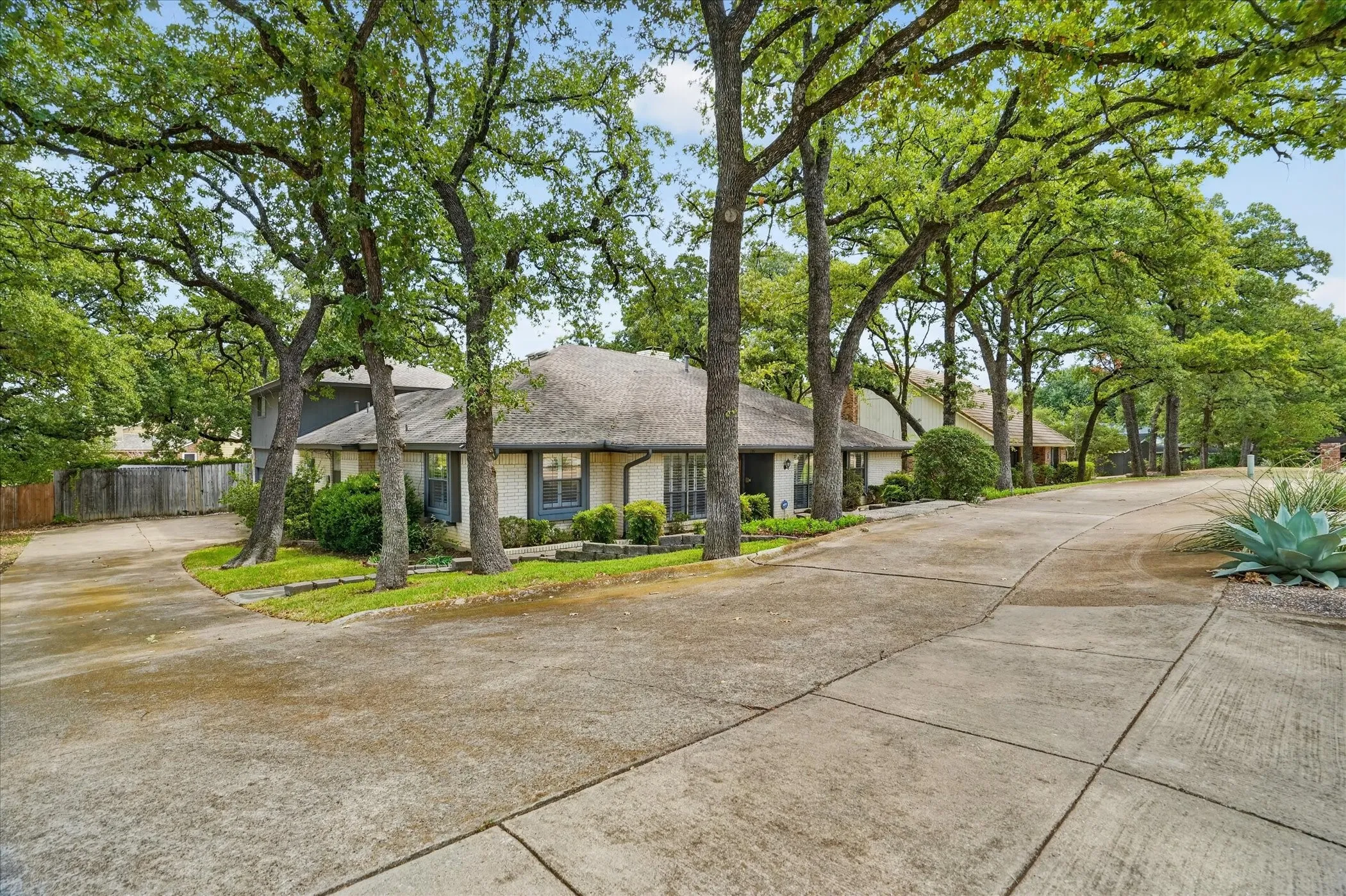 Plenty of parking with a circle drive and driveway to an oversized garage