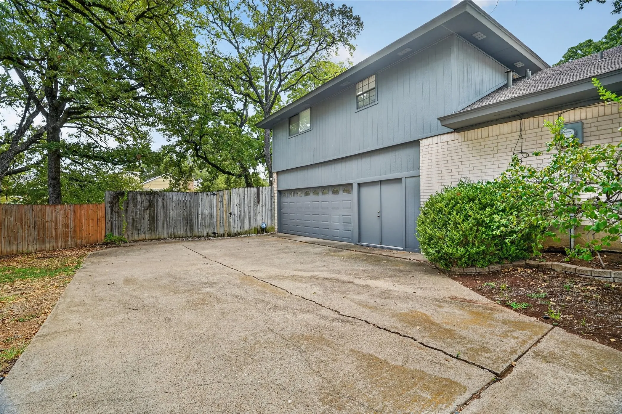 Plenty of parking with a circle drive and driveway to an oversized garage