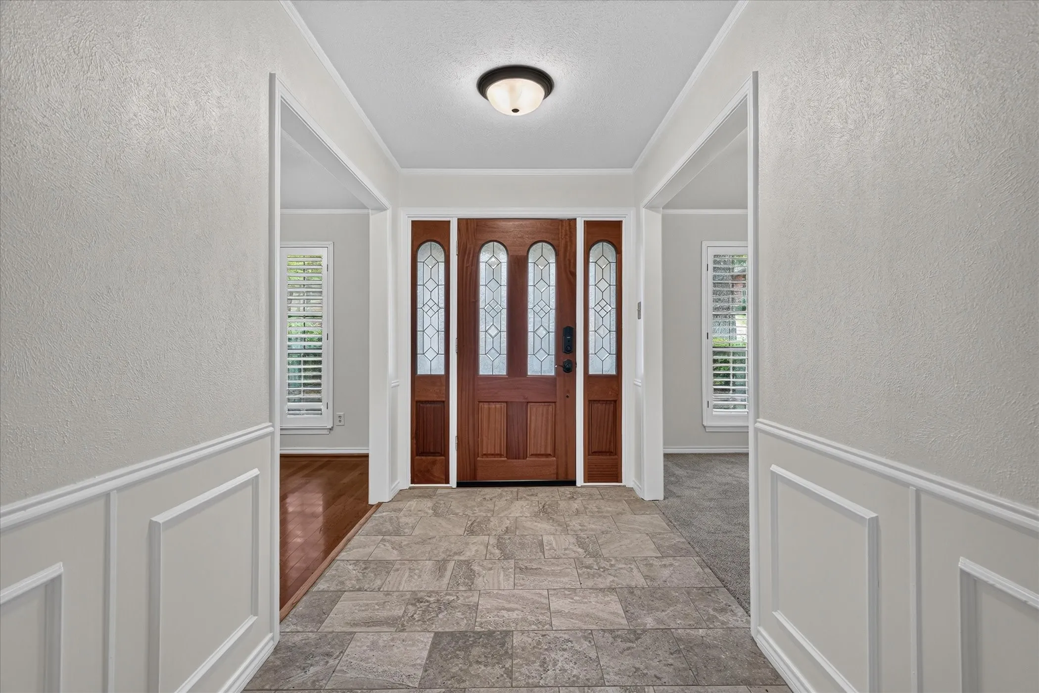 Freshly painted entryway with access to two versatile front rooms