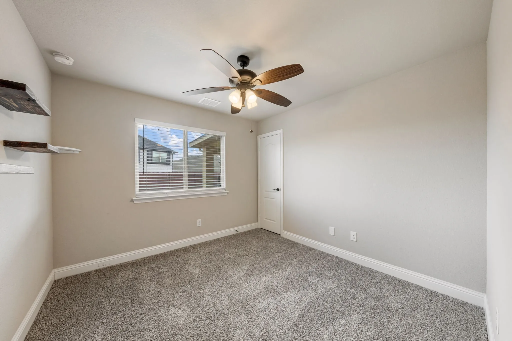 Recessed lighting, ceiling fan with light fixture, window with blinds, light-toned walls, and grey flecked carpeting