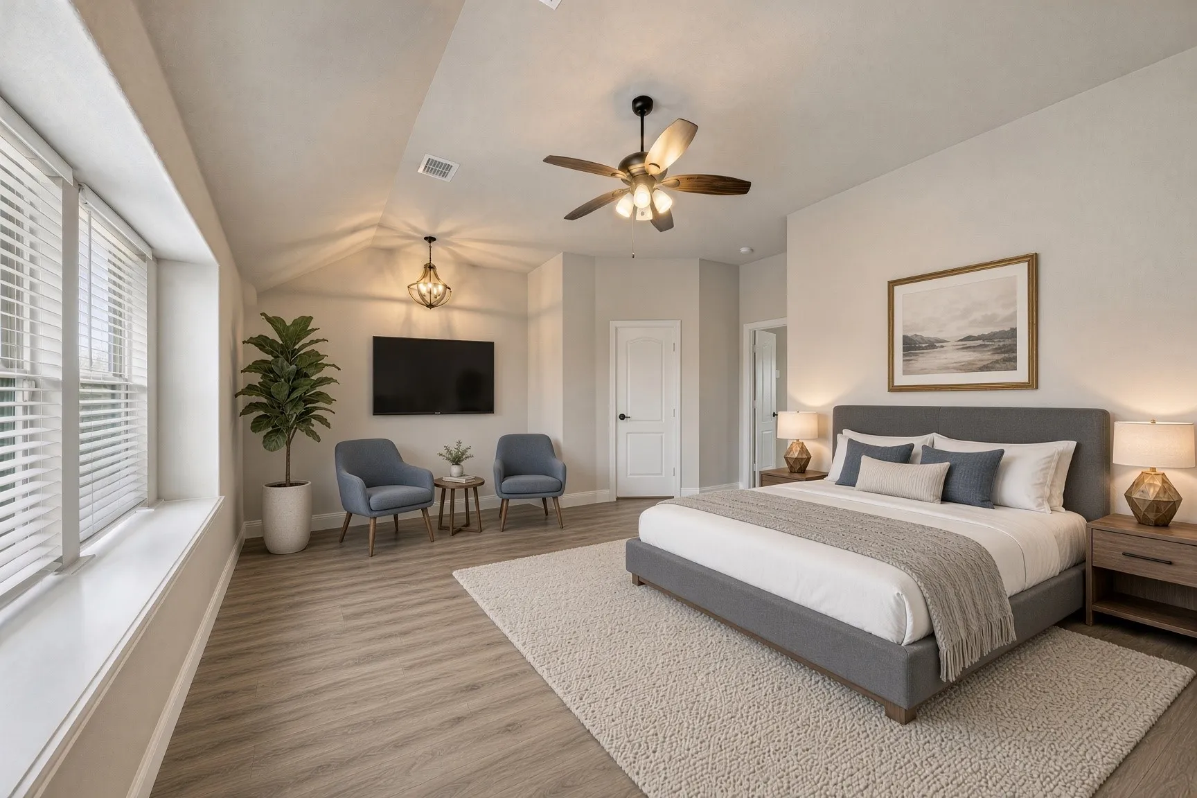 Vaulted ceiling with an attached ceiling fan, wood-finish flooring, built-in window seat, and an elegant chandelier