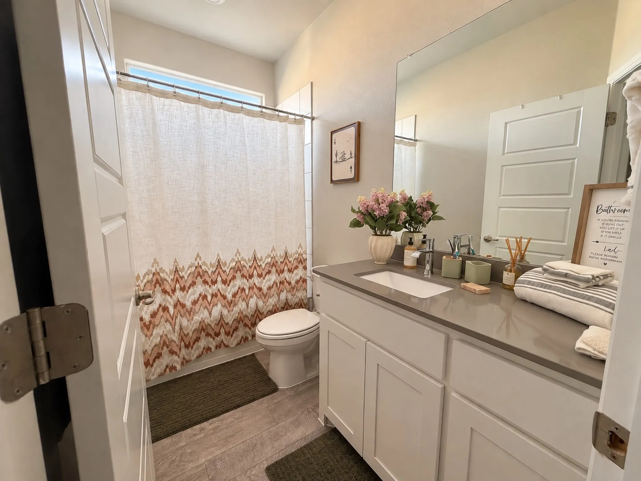 Vanity with integrated sink, stone-finish countertop, and white cabinetry