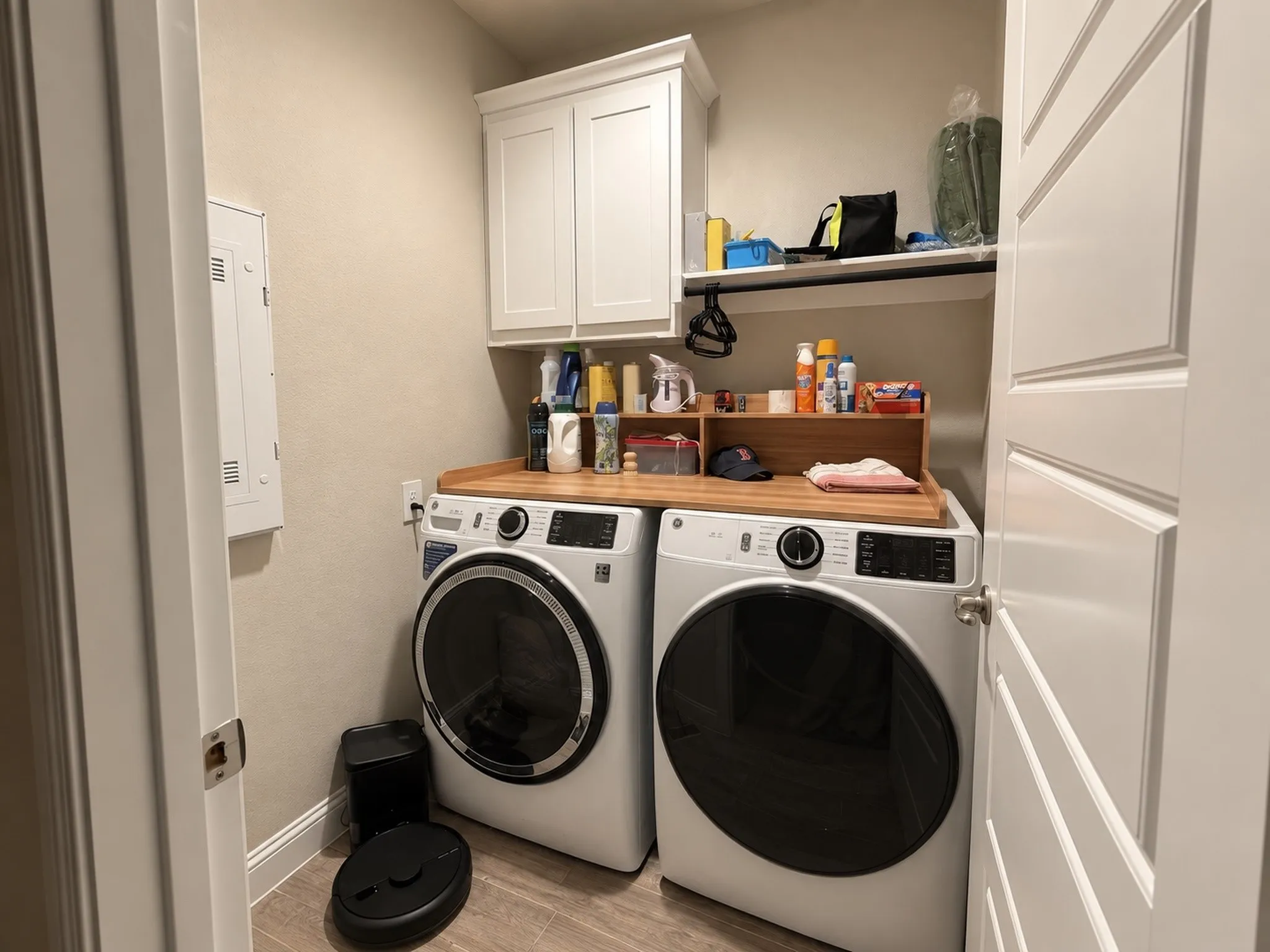 Built-in cabinetry, wood-finish countertop, and wood-finish flooring