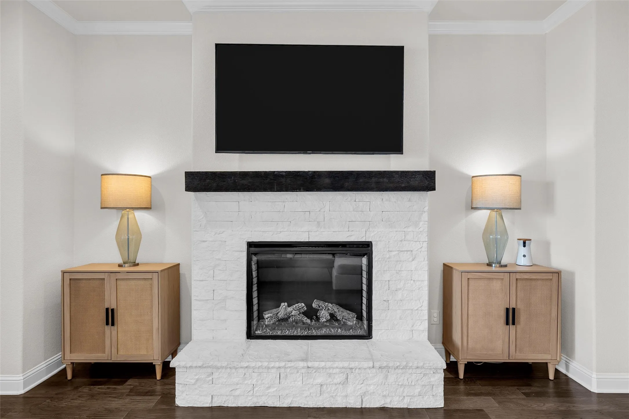 Stacked stone fireplace with a dark wood mantel and integrated firebox